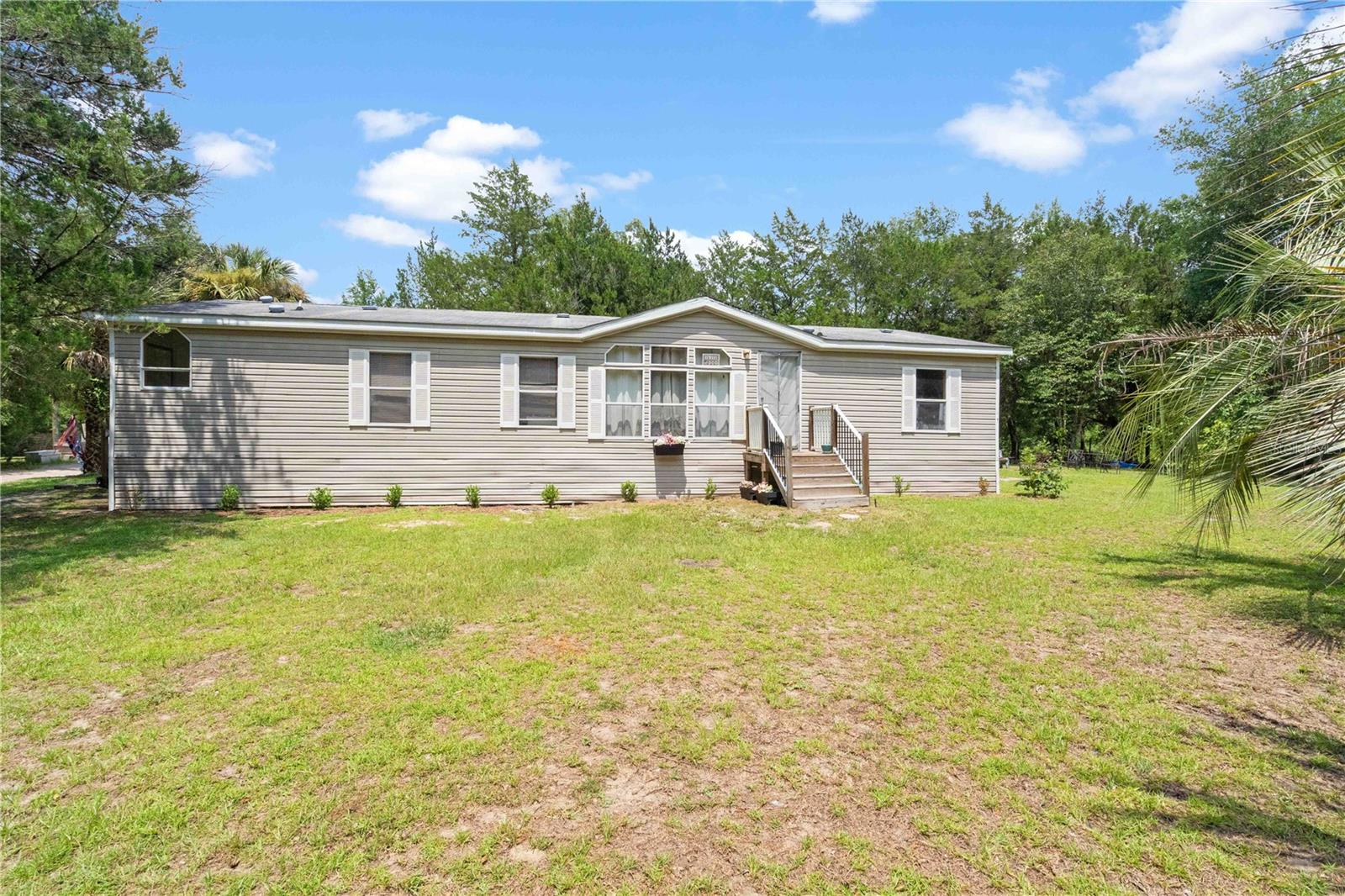 PEACEFUL COUNTRY LIVING BEGINS HERE! Tucked away just off a quiet paved dead-end street, this beautiful **8-acre oak-studded property** offers the privacy and natural beauty you've been searching for. Towering grandfather oaks create a picturesque setting for this well-maintained 2006 manufactured home featuring 3 bedrooms, 2 bathrooms, a semi-open floor plan, a cozy wood-burning fireplace, spacious kitchen with eat-at bar, and comfortable living spaces designed for everyday country living.
Whether you're looking for room to spread out, start a small hobby farm, or simply enjoy the peace and quiet, this property offers endless possibilities in a truly scenic setting. If you've been dreaming of wide-open spaces, mature shade trees, and a place to call your own, this one deserves a spot at the top of your list, make your appt for a tour today!
**Please note:** The home has been reset and is not eligible for FHA financing. Cash or conventional financing only.