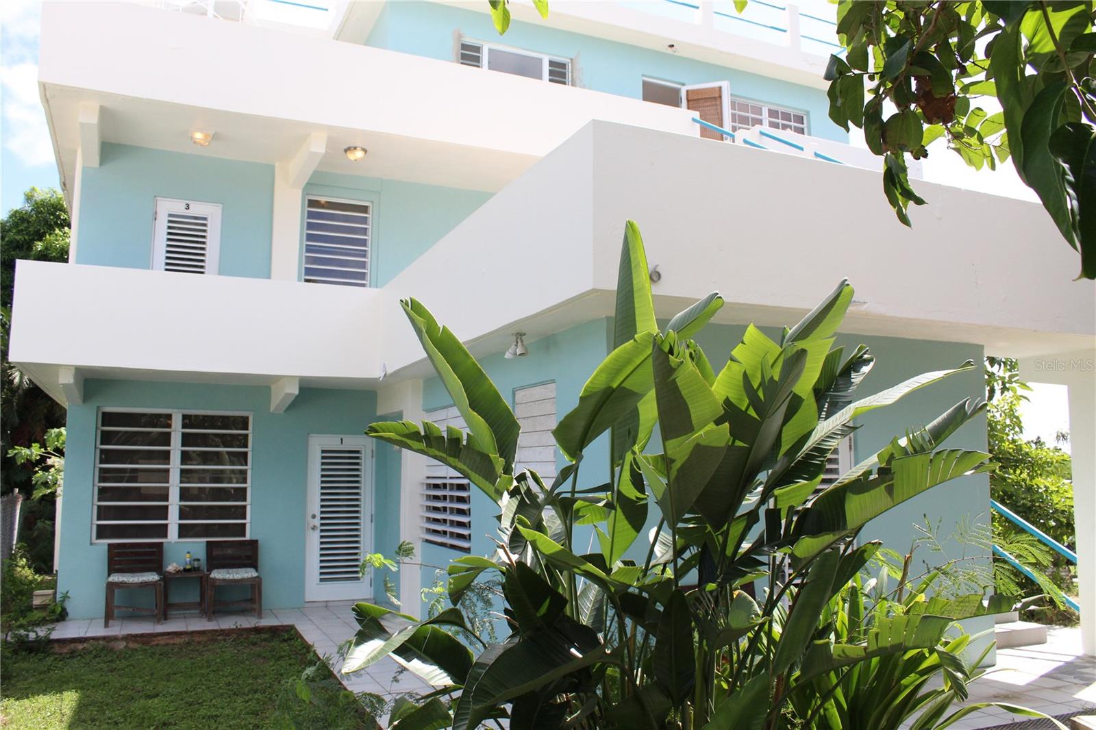 Acacia Guesthouse is located in the ever popular fishing village of Esperanza with the waterfront Malecon, restaurants, shops and beaches.

Welcome to Acacia Guesthouse, a charming and versatile property in the heart of Esperanza. Just a short stroll to Sunbay and other pristine beaches, the vibrant strip in Esperanza and the pick-up point for the famous bioluminescent bay tours.   This exceptional property offers a unique combination of comfort, functionality and breathtaking views.

The property features five fully furnished units including four one-bedroom apartments each with full kitchens, air conditioning, a bedroom and bathroom and outdoor sitting areas.

There is one large studio apartment with full kitchen, air conditioning and an outdoor seating area.

There are two spacious one bedroom apartments on the first floor along with a large storage and a shared laundry for the property.

The backyard is generously sized with room for a pool, vegetable gardens or however your dreams may take you.  There is an existing raised terrace and a storage structure housing the water cistern storage.

The second floor includes the bright and airy studio apartment and  a one bedroom apartment.  These units share a large open air terrace with outdoor seating.

The third floor has the one bedroom Penthouse that is currently being renovated.  The penthouse offers stunning ocean and countryside views.  All materials to complete the renovations are in the unit and a new mini-spit air conditioner has been installed.

The fourth floor is home to the rooftop terrace offering phenomenal 360-degree views of Sunbay beach, the Cayos in Esperanza and the surrounding countryside.  This is the perfect place for morning coffee or cool drinks in the afternoons.  This communal space is perfect for enjoying sunsets, star-gazing or hosting gatherings.

Acacia Guesthouse offers incredible flexibility with the new owner having options to continue the short-term vacation rentals or incorporate the units into long-term housing for locals creating an income stream.  The current owner has also successfully received a permit for scooter rentals that has since expired.  The new owners can independently  explore this option for additional income stream and attraction for the guests house.  The property has a driveway and parking for scooters behind the property.

There is plenty of room to add a swimming pool or more casitas (new owners to verify permits) to increase the properties value and attract more guests.

Acacia Guesthouse is a rare find in the thriving and vibrant Esperanza village.
