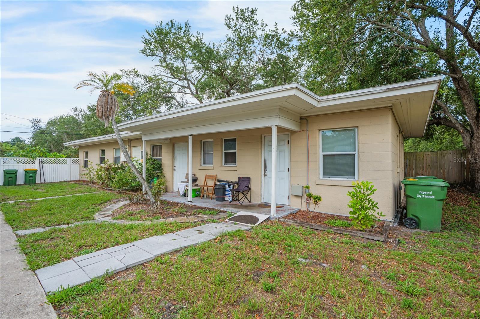 Virtually Staged. Rare 4-unit multifamily income opportunity in Sarasota's North Trail corridor, just minutes from downtown Sarasota, the bayfront, and the Ringling College of Art & Design district. The offering pairs dependable in-place cash flow with real value-add and redevelopment upside on an oversized ~0.40-acre city lot (17,555 SF). Four income-producing units include three residences at 3917 (a 1BR/1BA plus two efficiencies) and a spacious 2BR-plus-bonus home at 3919, with the 3919 unit turning now and targeting a market lease. All units are currently month-to-month, giving a new owner full flexibility to raise rents to market or reposition on their own timeline, with no long-term leases to inherit and clear upside as rents step up. Recent ownership has reinvested in the major systems, lowering near-term capital exposure: the shared 3917 roof was replaced within the last five years, water heaters for the three 3917 units were updated in 2023, and Unit A carries a 2022 AC air handler, while 3919 adds a newer AC and water heater, a carport, and a paved patio. Located in the City of Sarasota's North Trail redevelopment overlay, the parcel offers long-term assemblage and development optionality in one of Southwest Florida's most supply-constrained infill pockets, backed by steady rental demand from the surrounding Ringling College submarket. Offered at $524,900