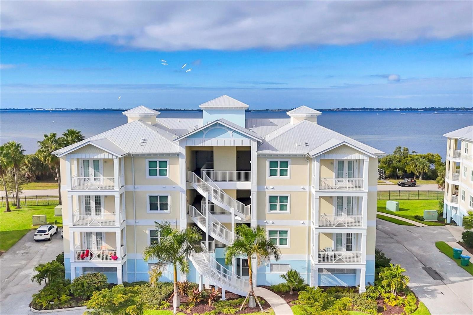 Bayfront splendor! Experience beautiful unobstructed sunsets and views of Palma Sola Bay in your true waterfront coastal retreat. Newly built in 2024 and located in the resort-style gated community of Palma Sola Bay Club, barely lived in and priced to sell. This spacious 3/2.5 floor plan lives more like a home than a condo. Quality block construction offers peace of mind along with IMPACT RATED windows and doors, metal roof and energy efficient features. The interior beckons you with easy maintenance glazed porcelain tile floors throughout. Multiple windows and 9’ ceilings create an airy ambiance with plentiful natural light. Interior features include crown molding, 5¼” baseboards, 8’ solid core doors and upgraded light fixtures. The well-appointed kitchen features stainless steel appliances, quartz countertops, shaker cabinets, glass tile backsplash and closet pantry. Your primary suite has French doors opening to the balcony, a spa-inspired bath with dual sinks and quartz countertop, linen closet and large walk-in closet. The Key West style buildings have elevator and stair access, under building parking with 2 premium assigned spaces and personal secure storage area as well as racks for kayaks or paddleboards. Amenities include community pool, clubhouse with kitchen, meeting room, pool table & fitness center. Grill poolside or relax around the fire pit, practice on the putting green or try your hand at Bocce Ball. PSBC is dog friendly, allowing 2 pets up to 100lbs. Even your pets have perks with the community dog park and a lit walking path with benches throughout the neighborhood. Launch your kayak into Palma Sola Bay or fish from the private community pier, a great place to catch an amazing sunset. Highly desirable location next to Palma Sola Bay, and minutes to the gulf beaches of Anna Maria Island. Convenient to shopping, restaurants, IMG Academy, and medical facilities. Start living your carefree Florida resort lifestyle now!