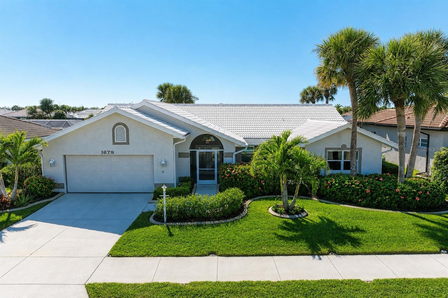 PRICE IMPROVED! – Don't Miss Your Opportunity! Welcome to this BEAUTIFUL and spacious 3 Bed 2 Bath, thoughtfully designed LAKEFRONT ~ POOL home located in the highly desirable WATERFORD GOLF COMMUNITY. Offering stunning water views from nearly every room. This exceptional residence blends comfort, quality construction, and refined luxury upgrades throughout.

From the moment you arrive, the home showcases fantastic curb appeal with an impressive double-door entry. Inside, soaring vaulted cathedral ceilings and a light-filled open floor plan create an inviting first impression. The living and dining areas flow seamlessly, while the expansive layout features generously sized rooms and a well-designed split-bedroom floor plan that offers both privacy and functionality. Beautiful, large Spanish Porcelain tile runs throughout the home, complemented by wide baseboard trim, recessed lighting, and interior sliding doors that enhance the bright, airy atmosphere and provide versatile living space options.

The kitchen is truly the heart of the home and a standout feature. Designed with both elegance and functionality in mind, boasting stunning waterfall solid stone countertops, custom cabinetry with abundant storage, and thoughtful luxury upgrades throughout. The spacious eat-in kitchen is perfectly positioned to overlook the sparkling pool and tranquil lake, creating a serene setting for everyday dining. A breakfast bar and matching stone bar table have convenient pool access making entertaining effortless, seamlessly blending indoor and outdoor living.

The primary suite serves as a peaceful retreat with calming lake views and an en-suite bath featuring dual vanities and a walk-in shower, offering both comfort and sophistication. There is an adjoining large attached bedroom providing flexible living options. This can be used as a home office, den, nursery, or easily locked back to a fully separate bedroom.  Allowing for a true split bedroom configuration. The large third bedroom on the opposite side of the home lives as a second primary suite or private guest room. 

Step outside to your private oasis, where a sparkling pool overlooks serene lake views and lush tropical landscaping, providing both tranquility and privacy. This well-built home includes valuable improvements such as HURRICANE IMPACT windows and doors.  A/C system replaced 2022. All new A/C DUCTWORK & blown-in insulation completed 2025. WATER FILTRATION system, irrigation system, epoxy garage floor, and interior sliders that maximize natural light and outdoor access.
Located within this gated community, residents enjoy exceptional amenities including a heated community pool and spa, fitness center, clubhouse, tennis courts, pickleball, and library. Golf membership to the 27-hole championship course is voluntary. Ideally situated near shopping, medical facilities, historic downtown Venice, and the beautiful Gulf beaches, this home offers the perfect blend of luxury, lifestyle, and convenience.

Don’t miss this exceptional opportunity to own a lakefront pool home in one of the area’s most sought-after gated golf communities.