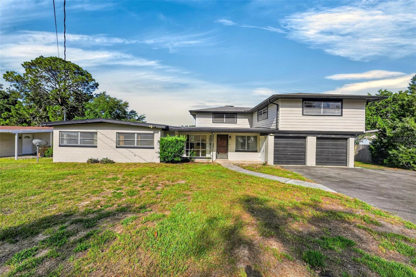 SO MANY POSSIBILITIES IN THIS MID CENTURY MODERN HOME SITTING ON LAKE MAGGIE WITH
CANAL ACCESS TO LAKE JOANNA!  ORIGINAL TERRAZZO FLOORS! 3 BEDROOMS DOWNSTAIRS WITH
HUGE BEDROOM UPSTIAIRS!  ALSO HUGE BONUS SPACE UPSTAIRS FOR THAT GAMEROOM, MAN
CAVE OR HOME SCHOOL AREA!  PLENTY OF ROOM FOR ALL THE KIDS AND PETS IN THIS QUIET
AREA OF EUSTIS JUST 6 MINUTES FROM DOWNTOWN!  WITH A LITTLE IMAGINATION THIS COULD BE
YOUR FOREVER HOME!  ROOF REPLACED IN 2024. NEWER SEPTIC SYSTEM, AC AND HOTWATER
HEATER!  JUST NEEDS YOUR LOVING TOUCH!