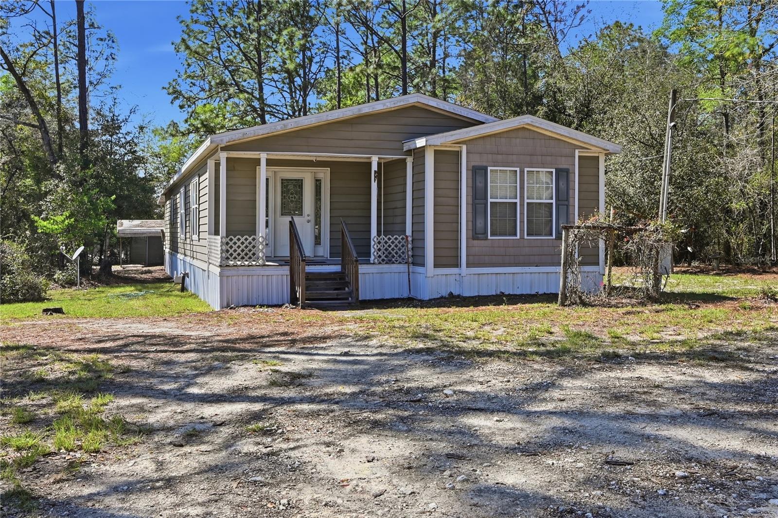 Spacious 3-bedroom, 2-bath home situated on a full acre in the tranquil Suwannee River Estates—perfect for those seeking peaceful rural living with added privacy. This fully fenced property offers a thoughtful layout featuring a welcoming living room, dining room, and a separate family room for added flexibility. The eat-in kitchen provides a comfortable space for everyday meals and gatherings. 
The primary suite includes an en suite bathroom with both a soaking tub and walk-in shower, along with a generous walk-in closet. Enjoy the outdoors from both the front and rear porches, expanding your living space and creating ideal spots to relax or entertain.

Recent upgrades include a brand-new roof, HVAC system, offering peace of mind and helping ensure the home meets insurance and lending requirements. This property combines space, comfort, and practicality in a serene setting.