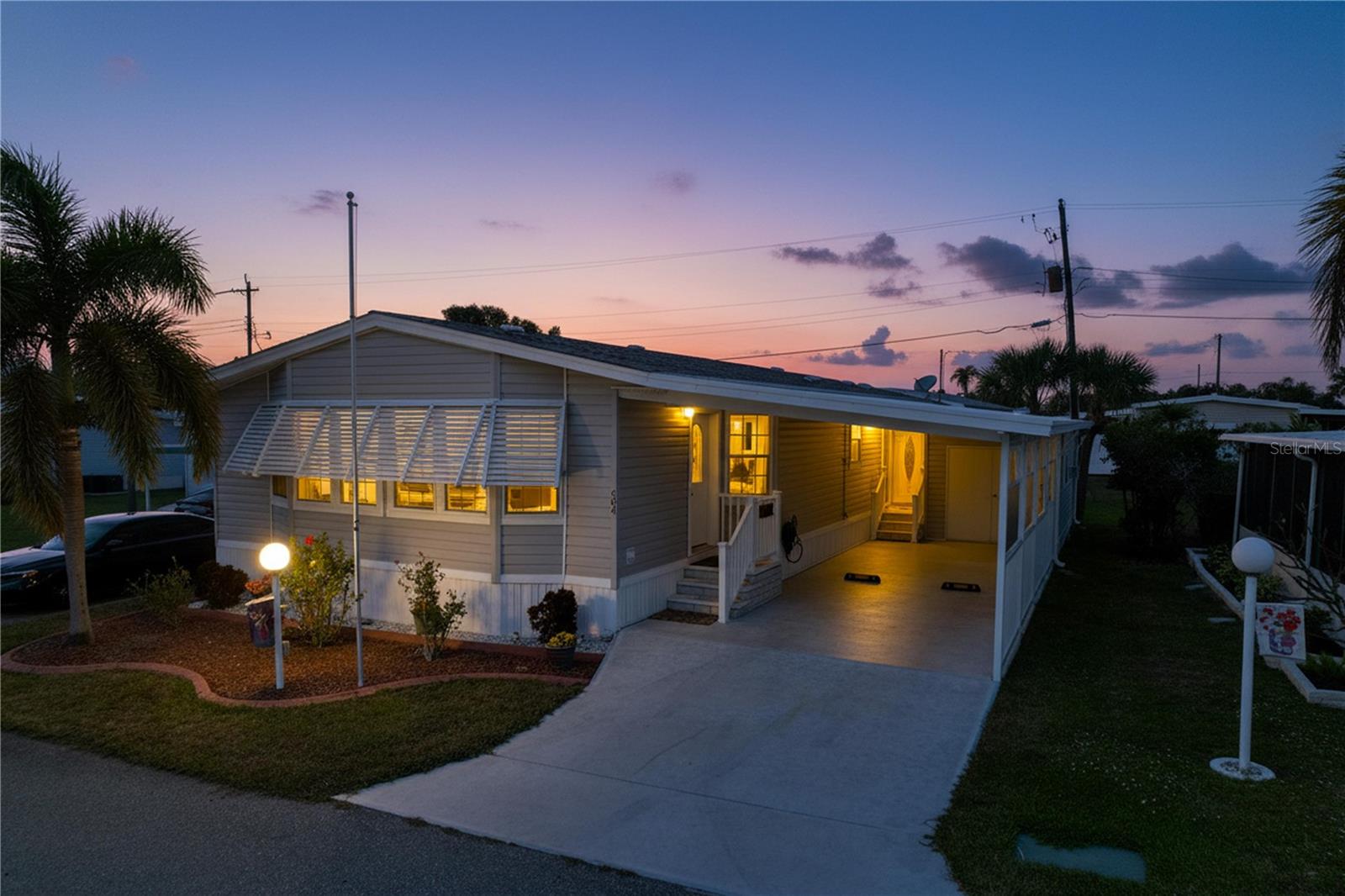 Welcome to Golf Lakes, a sought-after, resident-owned, gated 55+ community known for its exceptional value and resort-style amenities. Tucked away on a quiet cul-de-sac, this spacious 2014 double-wide manufactured home offers 2 bedrooms, 2 bathrooms, modern finishes, and an open, comfortable layout. The primary bathroom features dual vanities and a walk-in, jetted tub/shower. The kitchen boasts modern appliances, including a side-by-side LG fridge, and an island with seating - perfect for entertaining. The laundry room is equipped with a Samsung washer (top-loading) and dryer. Additional features include a 2-car tandem carport, a separate golf cart garage/workshop with its own wall/window A/C unit, as well as a RonAqua water softener system.

Low monthly HOA fees cover water, sewer, cable, internet, and access to an impressive list of amenities, including a heated pool and spa, a 9-hole pitch & putt golf course, a fitness center with sauna, pickleball courts, lawn bowling, shuffleboard, a clubhouse with an active social calendar, and four scenic lakes for fishing throughout the community.

Conveniently located near shopping, dining, medical facilities, and the beautiful Gulf Coast beaches, Golf Lakes offers an active, low-maintenance lifestyle in a friendly, well-maintained setting. Seasonal rentals permitted. Cooperative ownership. No pets.

An ideal opportunity for those seeking an affordable, move-in-ready home in a vibrant 55+ community.