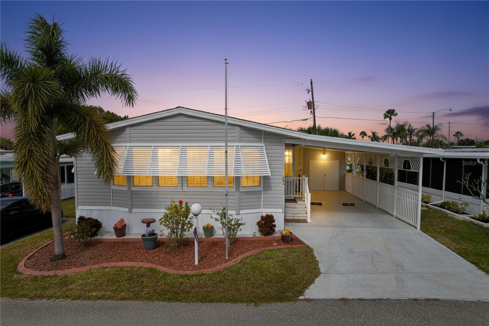 Welcome to Golf Lakes, a sought-after, resident-owned, gated 55+ community known for its exceptional value and resort-style amenities. Tucked away on a quiet cul-de-sac, this spacious 2014 double-wide manufactured home offers 2 bedrooms, 2 bathrooms, modern finishes, and an open, comfortable layout. The primary bathroom features dual vanities and a walk-in, jetted tub/shower. The kitchen boasts modern appliances, including a side-by-side LG fridge, and an island with seating - perfect for entertaining. The laundry room is equipped with a Samsung washer (top-loading) and dryer. Additional features include a 2-car tandem carport, a separate golf cart garage/workshop with its own wall/window A/C unit, as well as a RonAqua water softener system.

Low monthly HOA fees cover water, sewer, cable, internet, and access to an impressive list of amenities, including a heated pool and spa, a 9-hole pitch & putt golf course, a fitness center with sauna, pickleball courts, lawn bowling, shuffleboard, a clubhouse with an active social calendar, and four scenic lakes for fishing throughout the community.

Conveniently located near shopping, dining, medical facilities, and the beautiful Gulf Coast beaches, Golf Lakes offers an active, low-maintenance lifestyle in a friendly, well-maintained setting. Seasonal rentals permitted. Cooperative ownership. No pets.

An ideal opportunity for those seeking an affordable, move-in-ready home in a vibrant 55+ community.