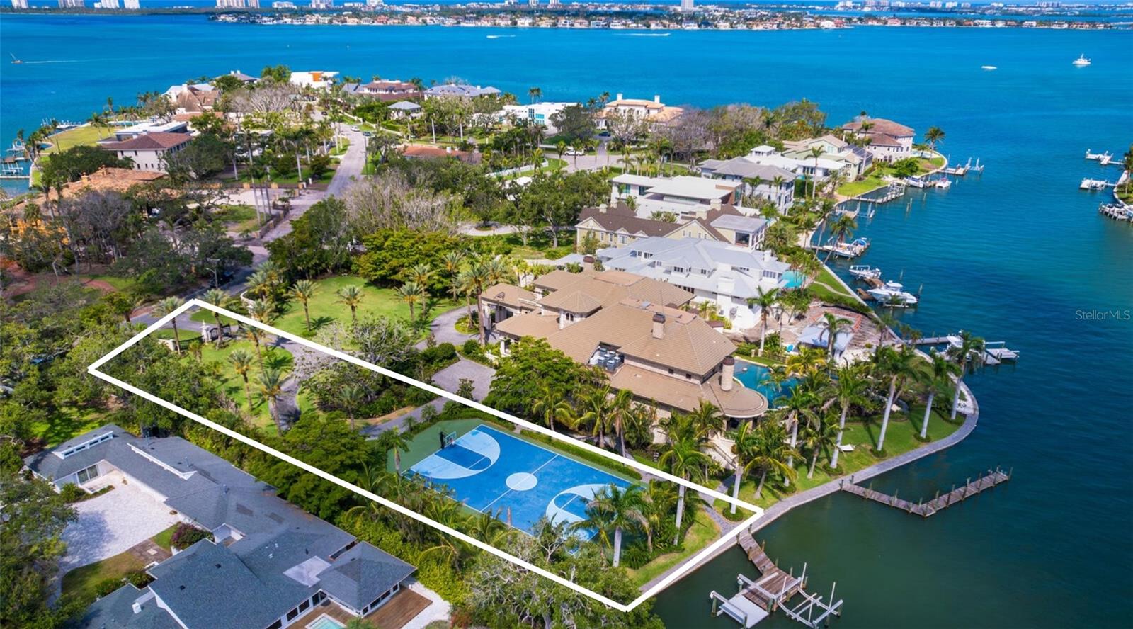 An exceptionally rare opportunity to secure a prime waterfront homesite in Sarasota’s most coveted neighborhood, Harbor Acres. Spanning approximately 35,000 square feet with 115 feet of waterfront, this expansive parcel offers the ideal canvas to create a custom residence in a location where new build opportunities are increasingly scarce. Positioned adjacent to a premier bayfront estate and currently improved with a private sport court, the property is surrounded by multi-million-dollar homes and mature tropical landscaping, offering the potential for stunning water views and seamless access to Sarasota Bay. With generous dimensions and a prestigious address just minutes from downtown Sarasota, Southside Village, and the Gulf beaches, this is a true legacy offering, an opportunity to build new in one of the city’s most iconic and tightly held enclaves, where opportunities like this are nearly impossible to come by. The adjacent estate at 1423 Hillview is currently offered separately, with the opportunity to purchase both together. Bank sign-off on the sale of this property may be required. The gate and driveway would need to be reconfigured.