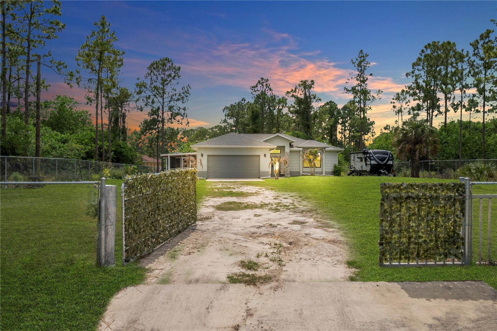 Beautiful residential property loaded with upgrades and located on a private dead-end street with waterfront views across the street! This well-maintained home features impact windows, tile flooring throughout, gutters around the entire house, and a spacious fenced yard with plenty of room for a future pool. Enjoy outdoor living with two screened lanais, including a corridor along the left side of the house and an additional rear screened lanai perfect for relaxing or entertaining. The property also offers a concrete side area ideal for extra parking, storage, or recreational use. The oversized 2-car garage includes epoxy flooring, garage door opener/control, and generous storage space. Additional features include generator hookup, RV hookup, and a spacious walk-in closet for added convenience. The kitchen comes equipped with appliances in excellent condition, including a stove with built-in air fryer, brand-new dishwasher, and microwave.This home combines comfort, privacy, functionality, and location — a fantastic opportunity for full-time living or seasonal enjoyment!