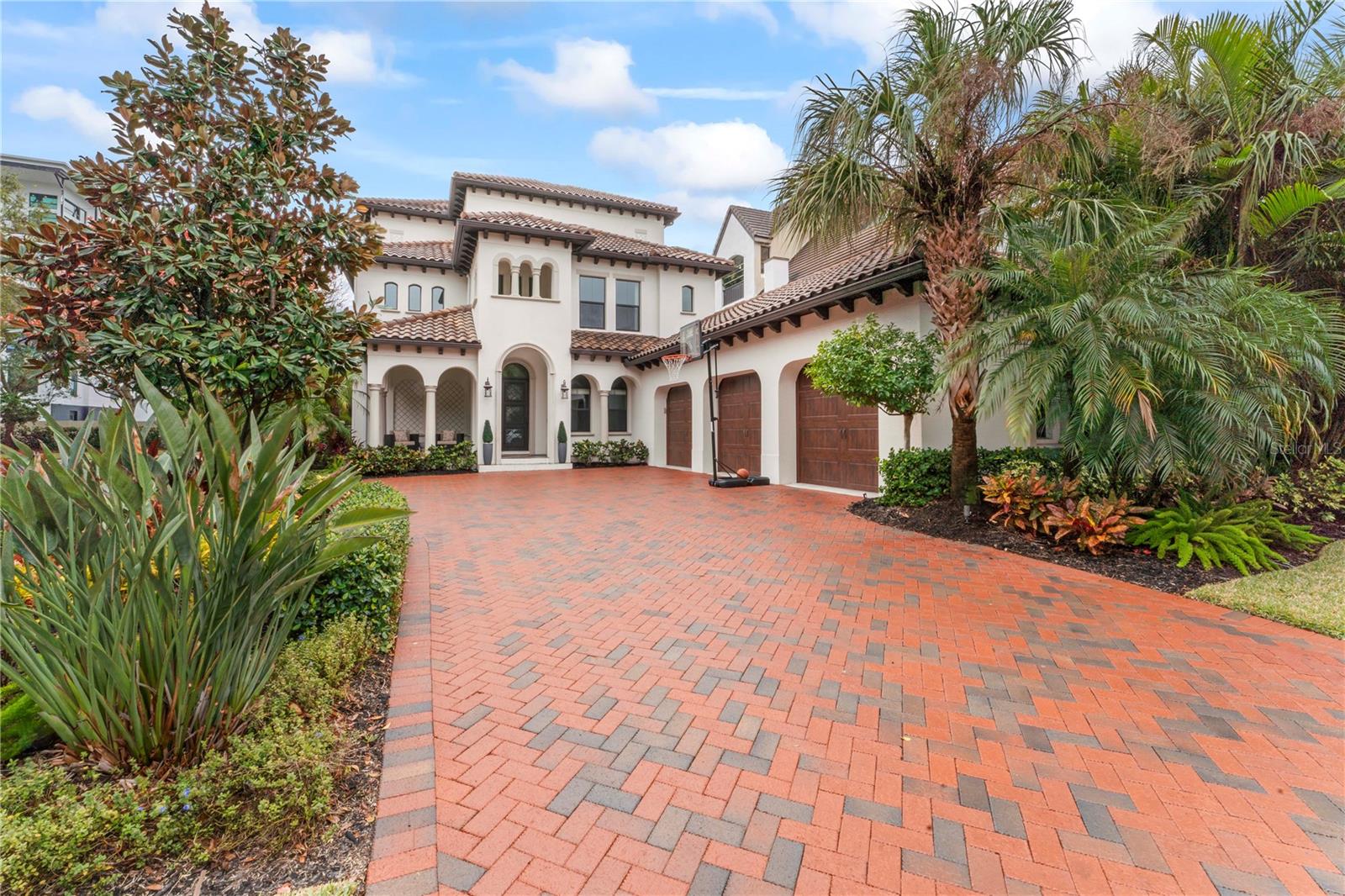Welcome to an exquisite residence nestled within the prestigious "high and dry" gated community of Westshore Yacht Club with absolutely no damage or flooding during Milton or Helene + a full whole house generator for added comfort! This elegant home offers a harmonious blend of luxury and comfort, designed to cater to the most discerning tastes. With five spacious bedrooms and 5 full and 2 half beautifully appointed bathrooms, this residence provides ample space for both family living and sophisticated entertaining. Spanning 5,179 heated square feet and 7,483sf under roof, the home features expansive living areas adorned with high-end finishes and thoughtful details. The gourmet kitchen is a chef's dream, equipped with top-of-the-line appliances and generous counter space, perfect for culinary creations. The open-concept design seamlessly connects the kitchen to the living and dining areas and the outdoor kitchen, creating an inviting atmosphere for gatherings. Step outside to your private oasis, where a sparkling pool beckons for leisurely afternoons under the Florida sun. The meticulously landscaped grounds offer a tranquil and very private retreat. Whether you're enjoying a quiet evening by the pool or hosting a lively soirée, this outdoor space is designed for both relaxation and entertainment. Another wonderful entertainment area is the enormous 3rd floor bonus room complete with a top of the line AV system with a projection tv and an inviting roof top deck offering STUNNING WATER and SUNSET VIEWS! This home is a sanctuary of sophistication, offering the perfect balance of privacy and community living as a member of the Westshore Yacht Club with 2 marina front pools, restaurant, bar, gym, and spa. Experience the epitome of refined living in this exceptional Tampa residence, where every detail has been carefully curated to provide a lifestyle of unparalleled elegance and comfort.