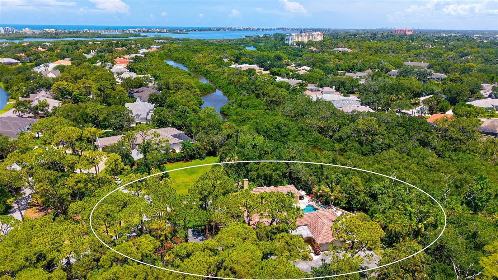Discover incredible value and endless potential in this beautifully maintained 3 bedroom, 3.5 bath home, tucked into lush tropical landscaping, on a quiet cul-de-sac in The Oaks Bayside.  A grand traditional residence, with generous sized rooms, flexible living areas, and a private outdoor setting, the possibilities here are limitless.  Step into the marble entry through the double front doors, and you will love what you find inside. Just off the entry, a cozy den with fireplace sits opposite a spacious guest suite. The heart of the home is the light-filled great room, with formal living and dining areas opening through French doors to the covered patio and resort-style pool. The kitchen combines beauty and function with granite countertops, center island cooktop, breakfast bar, and a sunny nook overlooking the pool. The elegant primary suite offers marble floors, soaring ceilings, plantation shutters, and private access to the pool for an early swim or late-night dip. A glamorous dressing area leads to the spa-like bath with soaking tub, walk-in shower, and marble finishes. Two additional oversized en suite bedrooms provide comfort and privacy for guests. A large laundry room with ample cabinetry and an adjacent private sauna completes the interior. Outdoors, the free-form pool with rock outcroppings and waterfall is a showstopper, surrounded by both shaded and open areas for dining and relaxing. With two adjoining lots preserved as gardens, this home offers rare seclusion in a natural setting. The Oaks Club features two 18-hole championship golf courses, an award-winning tennis program, pickleball courts, a state-of-the-art fitness center and a junior Olympic, community pool as well as a celebrated social calendar, and incredible dining options. There is currently no waiting list for either Golf or Sports/Social membership