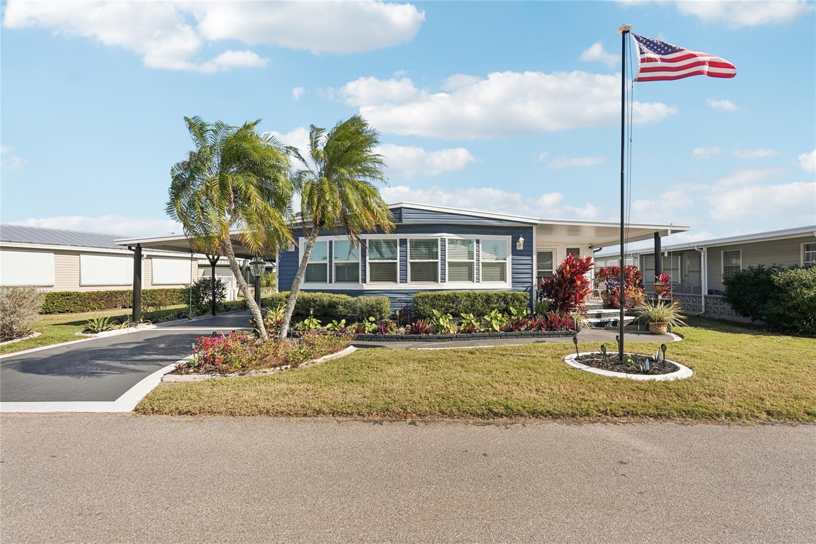 Welcome to Kings Gate Club, a spectacular 55+ gated cooperative in beautiful Nokomis, Florida! This home was remodeled with over $150,000 in upgrades, and no expense spared. A full list of items is available in the MLS attachments; just ask your agent to share it with you! Even approaching the home, you’ll know this one is special when you see the pristine landscaping, fresh paint, and new windows. One of the most defining features of the home is the open floor plan, where walls were taken down to allow the kitchen, living room, and dining area to flow together into one open living space. The laundry was moved to a closet in this living space, and there is also a mud room type space when you enter the door. The subfloors were replaced throughout the home, and new luxury vinyl plank was laid down. To add to the luxuriousness, crown molding and taller base molding were added. The kitchen has granite countertops and new stainless steel appliances, including a raised dishwasher and ice maker. There is drywall and recessed lighting throughout the home. The guest bedroom has an ensuite bathroom, with a Jack and Jill configuration, and a barn door to separate it from the main living space. The master suite is at the rear of the home, and features an ensuite bathroom with dual vanities and walk-in tile shower, and remote controlled blinds on the windows! The Florida room is completely enclosed with window AC units, adding to the overall heated and cooled living space. The sliding glass door leading to the screen porch is a triple slider, allowing the outside to come in, and there is a deck out back, leading down to the pond. Under the carport, there is a huge storage shed! Furnishings are negotiable! Kings Gate Club is just minutes to beaches, shopping, restaurants, Sarasota Memorial hospital and I-75, yet hidden from public view. Even Siesta Key beach, which is ranked #2 beach in the US and 14th in the world, is less than 17 miles away! Among the many amenities that this community offers is the oversized swimming pool with lap lanes, 24-hour fitness center, saunas, community hot tub, game and craft rooms, woodworking shop, pickleball, tennis, bocce ball and shuffleboard courts for the sport enthusiast. Included in your HOA fees of only $438 a month (paid quarterly) are over 200 cable channels and state-of-the-art fiber optics internet, mowing, garbage, and water.