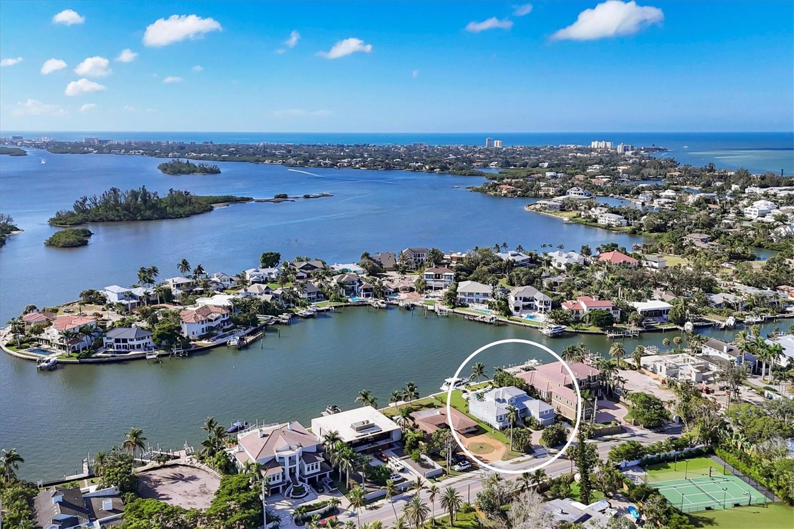 Look no further. Welcome home to your coastal Siesta Key waterfront retreat, a boater’s dream come true. On the desired north end of Siesta Key, this four-bedroom, four-bath residence spans 4,622 square feet of meticulously designed living space. Elevated above flood plain, the residence blends architectural craftsmanship with a premier waterfront lifestyle. Directly on the Intracoastal Waterway with no fixed bridges, the property offers swift access to Big Pass and open Gulf waters. The dock presents panoramic bay views and a new 95-foot seawall with a 40-foot slip equipped with power, water and solar lit pilings, ideal for boating or serene sunrise and sunset viewing. The outdoor experience is elevated by a heated saltwater pool and spa, complete with smart controls, waterfall features and porcelain shellstone decking. Inside, a gourmet kitchen centers the home, featuring a Sub-Zero refrigerator, six-burner Dacor gas range with stainless vent hood, Advantium microwave-convection oven, wine refrigerator, wet bar, soft-close cabinetry with glass uppers, decorator granite surfaces, expansive island and illuminated custom cabinetry. The open-concept family room showcases a cathedral ceiling with sweeping bay vistas, creating a striking indoor-outdoor connection. The expansive primary suite features a private waterfront balcony, new carpet, custom walk-in closet and a spa-style en-suite with a deep soaking tub, frameless rain shower, and dual vanities. Two guest bedrooms are on the first floor, including a rear en-suite with a private entrance that also serves as a dedicated pool bath. A bonus room used as a game and fitness space offers flexible potential and can easily be converted into a fourth bedroom. This residence is within the city limits, allowing for potential short-term rental income, making it an attractive opportunity for personal enjoyment and investment. Additional highlights include hurricane-impact windows and doors, Hunter Douglas custom treatments, crown molding, Brazilian cherry wood flooring and refined interior finishes throughout. Professionally landscaped grounds with new sod, an irrigation system and hardscape pathways complete the setting. Minutes from Siesta Key Beach and Village and a short drive to Southside Village and downtown Sarasota, this residence merges waterfront access with design, privacy and location, offering a rare opportunity to own a premier property on Florida’s Gulf Coast. Click on the fly-through video and Matterport walk-through for more images. Live where every day feels like a resort vacation, make it come true!