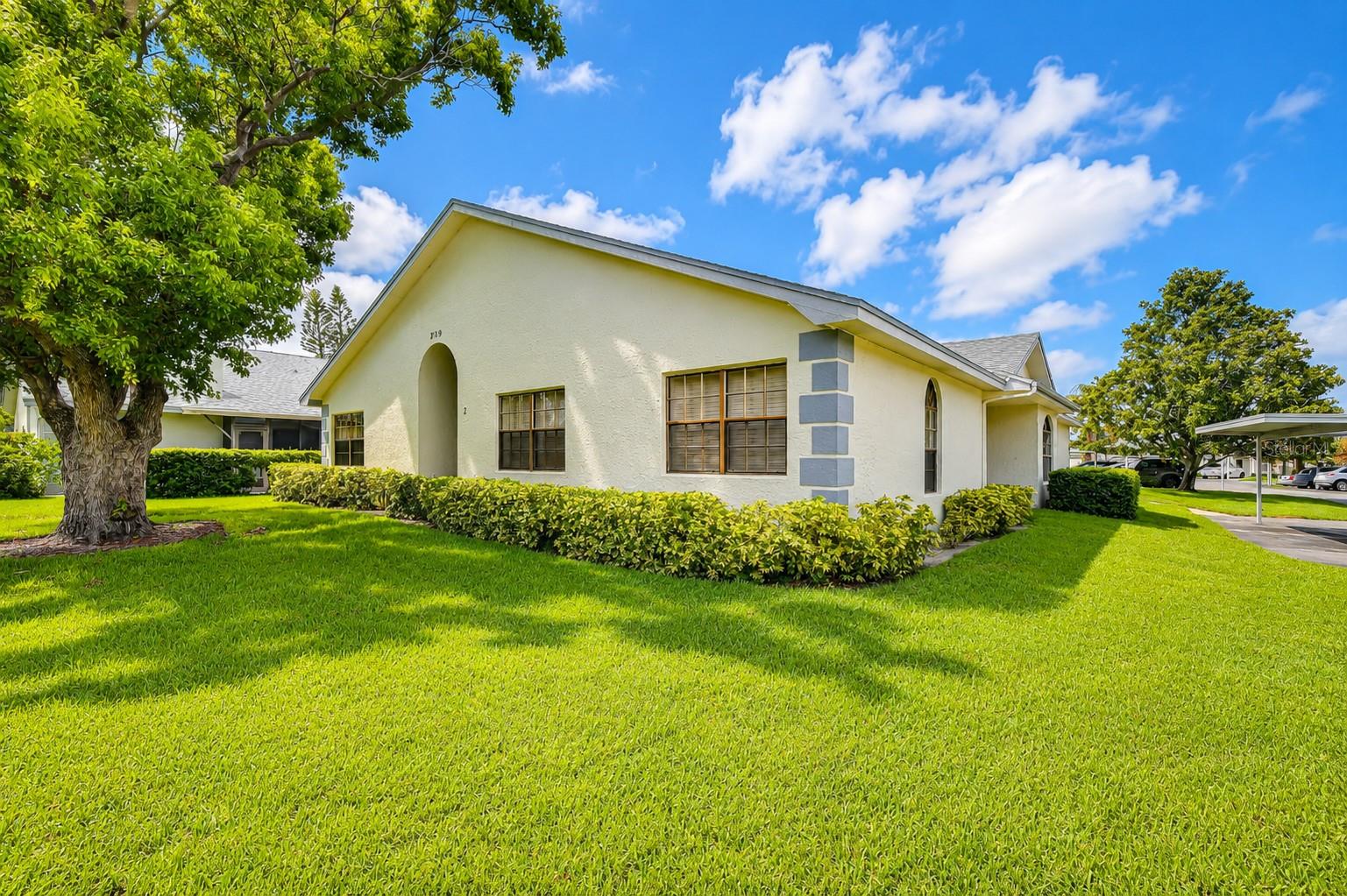 Available now for annual lease! Enjoy easy single-story living in the desirable Bryn Mawr community, located in the heart of Countryside. Nestled among beautiful oak and palm trees, this inviting 2-bedroom, 2-bathroom condo offers a spacious layout and an ideal setting.  The open-concept floor plan features soaring vaulted ceilings, a cozy wood-burning fireplace, and an abundance of natural light that creates a bright and welcoming atmosphere. The kitchen is equipped with stainless steel appliances, ample cabinet storage, and a breakfast bar that opens to the spacious living and dining areas—perfect for both everyday living and entertaining.  The generously sized primary suite easily accommodates a king-size bed and provides a peaceful retreat. Both bathrooms have been tastefully updated, and an enclosed private patio offers the perfect spot to relax and enjoy the outdoors.  Two assigned parking spaces (one covered) conveniently located directly in front of the unit. Residents also enjoy exceptional amenities, including a large swimming pool, barbecue area, clubhouse, and fully equipped fitness center.  Ideally situated just minutes from shopping, dining, and top-rated golf courses, the location is hard to beat. Directly across the street is the Countryside Recreation Center, featuring pickleball courts, a playground, picnic areas, outdoor fitness equipment, a gymnasium, basketball courts, and more. Plus, you're only about 10 minutes from both vibrant Downtown Dunedin and charming Downtown Safety Harbor, where you'll find waterfront parks, restaurants, breweries, festivals, live entertainment, and weekend events year-round. Don't miss the opportunity to make this wonderful condo your next home!
