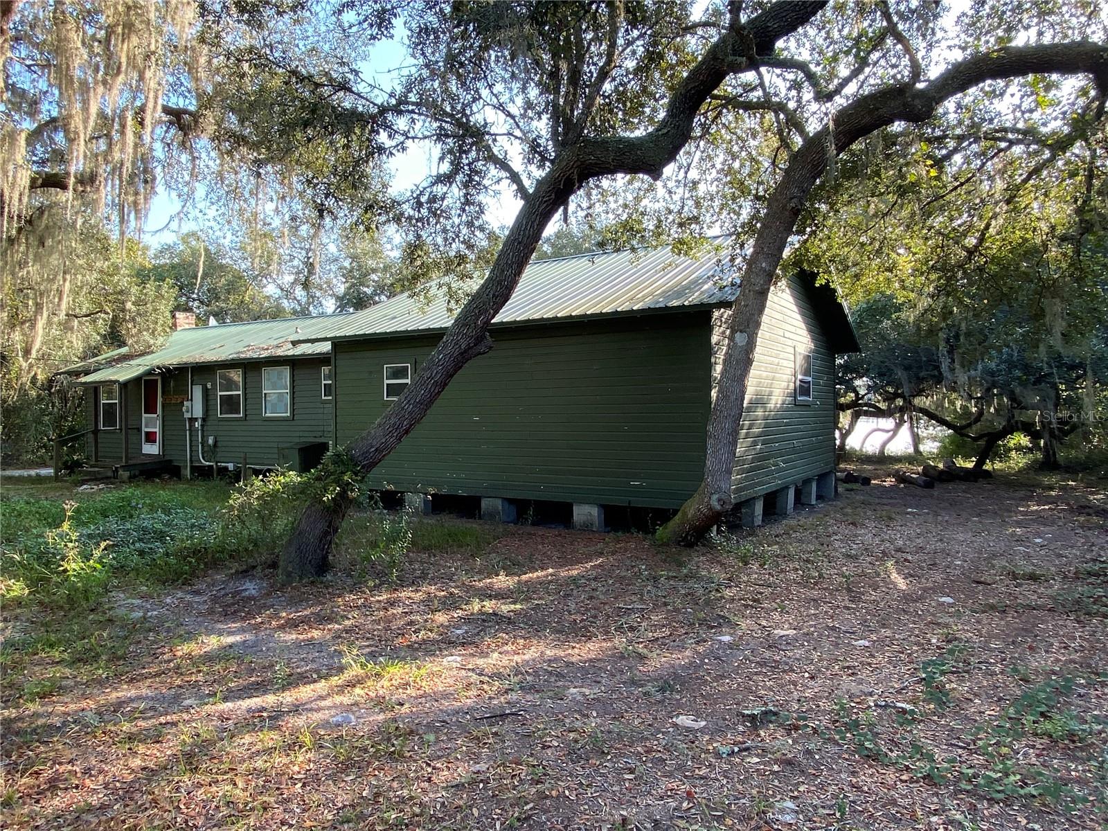 Step into the gin-clear, spring-fed waters of Lake Catherine — right from your own 150+ feet of private shoreline. This 2-bedroom, 2-bath recreation cabin sits deep in the Ocala National Forest, offering the perfect weekend getaway for fishing, kayaking, swimming, and campfire cookouts at the on-site Whole hog BBQ pit. With some TLC, this becomes your personal base camp for everything the forest has explore. Camp is on leased land from the National Forest Service. Price reflects NFS directive that the lease will not be renewed after the lease expiration in 2040, and property is to be returned to its natural state at that time. Property Cannot be full time residence, must maintain primary residence elsewhere. Power is not on, buyer to make arrangements for inspections. No range No refrigerator.