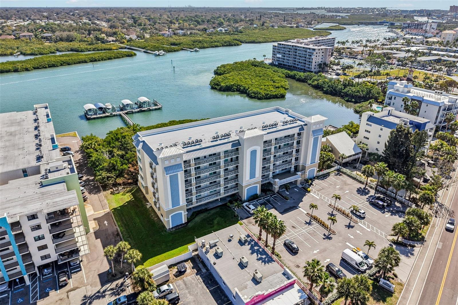 $50,000 Price Improvement!  MOTIVATED SELLER!  Life is short, BUY THE BEACH HOUSE!  Welcome Home to your stunning, fully furnished, turn-key (all furniture, kitchenware, decorations, and linens included), 2nd floor luxury condo unit at Dolphin Key, located directly on the Intracoastal Waterway in beautiful Indian Shores within walking distance of several great restaurants.  Recently built in 2017 in compliance with the latest Florida hurricane building codes, this unit had ZERO DAMAGE FROM THE 2024 STORMS. Owners in this exclusive 30-unit community enjoy the added safety of post-tension reinforced concrete construction, concrete pile raised foundation, reinforced concrete/metal standing seam roof, HURRICANE RATED IMPACT WINDOWS AND DOORS throughout each unit, and monitored interior fire alarm/sprinkler systems.  The building has a new roof and was painted in October 2023, and the HOA board is very friendly and proactive in keeping the building and grounds in pristine condition.  Relax and enjoy panoramic Intracoastal Waterway views from your massive 20' x 30', 600 square foot terrace (only 2nd floor units have a 20' x 30' terrace, all other units have 10' x 30' balconies) or take a short walk across Gulf Blvd to enjoy beach access to the sugar sand Indian Shores beaches and turquoise waters of the Gulf of Mexico. You will fall in love with this open concept condo the moment you walk through the front door. 1,560 sq ft, 3 large bedrooms, 2 full bathrooms, 1 under building assigned parking space, 1 parking lot assigned parking space, plenty of guest parking, and deeded use of Cabana 10 to store all of your beach gear. The kitchen was remodeled in 2019 and features 42" KraftMaid custom wood cabinetry with soft close hinges, pantry cabinet, Lazy Susan, oversized quartz countertops, and stainless-steel appliances.  This very energy efficient unit also features a tankless hot water heater.  The large master bedroom with Intracoastal Waterway views and sliding door access to the terrace also includes a large walk-in closet and an ensuite bathroom with a walk-in shower. Bedrooms 2 and 3 are spacious and have plantations shutters.  All 3 bedrooms have brand new luxury vinyl plank flooring.  Building extras include keypad coded access to the lobby and amenities areas, large fishing dock open to all residents, heated swimming pool and spa, 2 community bbq grills with piped in natural gas, fire pit with outdoor seating, gazebo, kayak storage racks, and a GATED DOG PARK AREA on the south side of the building.  Dolphin Key pet policy is 2 pets allowed, dogs and/or cats, 1 pet up to 50 lbs. or 2 pets not to exceed 50 lbs. in combined weight.  Don't miss this great opportunity to be an owner in this exclusive condo community. This one won't last long. Make your private showing appointment today!