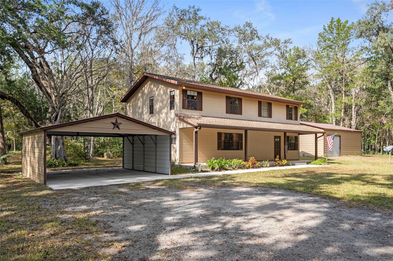 Escape the noise without sacrificing convenience on this rare 4.8-acre property tucked away in one of Brooksville’s most peaceful settings, just moments from the renowned Chinsegut Wildlife & Environmental Area. Surrounded by towering oaks, mature orange trees, and abundant wildlife, this is the kind of property that’s becoming increasingly difficult to find.

The spacious 2,288-square-foot home offers 2 bedrooms, 2 full bathrooms, and an inviting layout designed for comfortable country living. At the heart of the home, a wood-burning fireplace creates the perfect gathering space, while oversized living areas provide plenty of room to relax, entertain, or customize to fit your lifestyle.

Outside, the possibilities continue. A covered 2-car carport with a sidewalk leading to the home welcomes you in, while the impressive 30’ x 30’ metal building is ideal for a workshop, hobby space, equipment storage, or future projects. An additional storage shed provides even more flexibility.

Whether you dream of gardening, raising animals, storing recreational vehicles, or simply enjoying the peace and privacy of nearly five acres, this Agriculturally Zoned (AG) property offers the freedom to make it your own. A drainage swale located at the front corner of the property helps direct water away, providing excellent natural drainage across the land.

Spend your mornings sipping coffee while watching deer wander through the trees, harvest fresh oranges from your own yard, and enjoy the serenity that only acreage can provide—all while remaining within easy reach of Brooksville, shopping, dining, and the Suncoast Parkway.
If you’ve been waiting for a property that offers serenity, usable acreage, a spacious home, and the outbuildings to support your hobbies or business, this is one you won’t want to miss.