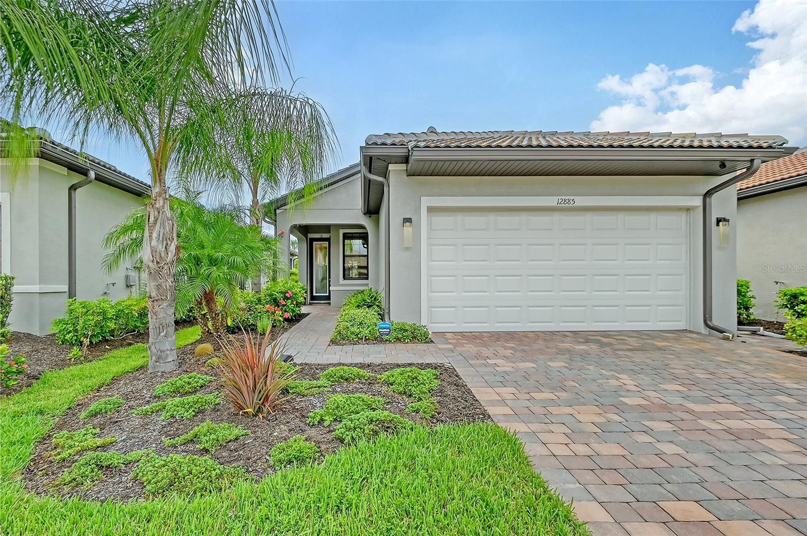 Enjoy resort style living in this open concept move in ready 4 year old home!  The IslandWalk community is rich with activities where there is something for everyone.  No need to worry about lawn care, weeding or tree trimming, it’s part of the package.  IslandWalk is just 5 minutes from Wellen Park, Publix, Costco or Cool Today Park/Atlanta Braves stadium.  Walk, bike or take the golf cart to get the most out of Florida’s beautiful environment and pleasant winter weather.  This location is within 30 minutes to Gulf of Mexico public beaches and historic downtown Venice on the Island.

This home features 3 bedrooms and 2 bathrooms with spacious closets and generous storage.  The kitchen features a convenient pantry, under counter lights, oversized island and quality Artistokraft white cabinets with granite countertops.  Dependable stainless steel whirlpool side by side refrigerator and dishwasher, complement a 2-year-old Kitchenaide microwave and Fridgidare oven.  The laundry room is equipped with top loading whirlpool washer and dryer.

The spacious master bedroom has plenty of room for a king bed.  An en-suite bathroom has 2 sinks with granite countertops, walk in shower and a well-lit master closet.  The second bedroom is conveniently located next to the 2nd bath.  The third bedroom can easily be used for guests or office space, whatever fits your lifestyle.  The closet is designed to be used either way.
Locking accordion hurricane shutters were installed in 2023.  The entry door is impact resistant as well as the window in the master bathroom.  The solid concrete block structure, tile roof and steel framing are built to last.  The exterior of this home was professionally painted in November 2023.  The exterior lighting was updated and is controlled by a timer switch located by the front door.  This home was occupied full time and was climate controlled by a Lennox Elite HVAC system at all times.  There were no pets or smoking inside and it is well ventilated.

Sit on the lanai and enjoy a cup of coffee and watch the sun come up over the butterfly garden.  Monarch butterflies are frequent visitors along with yellow cloudless sulfur butterflies that find their home on a casia tree.  

IslandWalk is a convenient and friendly community.  When you are away, you can monitor the inside and outside with Blink cameras and a Simply Safe security system.  The system monitors any activity within the range of the cameras as well as the internal and external temperatures.  The system will send an alert to your phone so you can respond appropriately.
 
Last, but not least is a 2 car garage with 2 large metal shelving units.  MyQ garage door is operated by an app on your phone.  It can be opened or closed from any location with just 2 clicks.  Also included are 2 remote controls.  The epoxy floor is easy to maintain and resists dirt and stains.  The water softener helps to keep appliances and plumbing in good working order.
Yes, there’s more!   Schedule a tour and see for yourself!