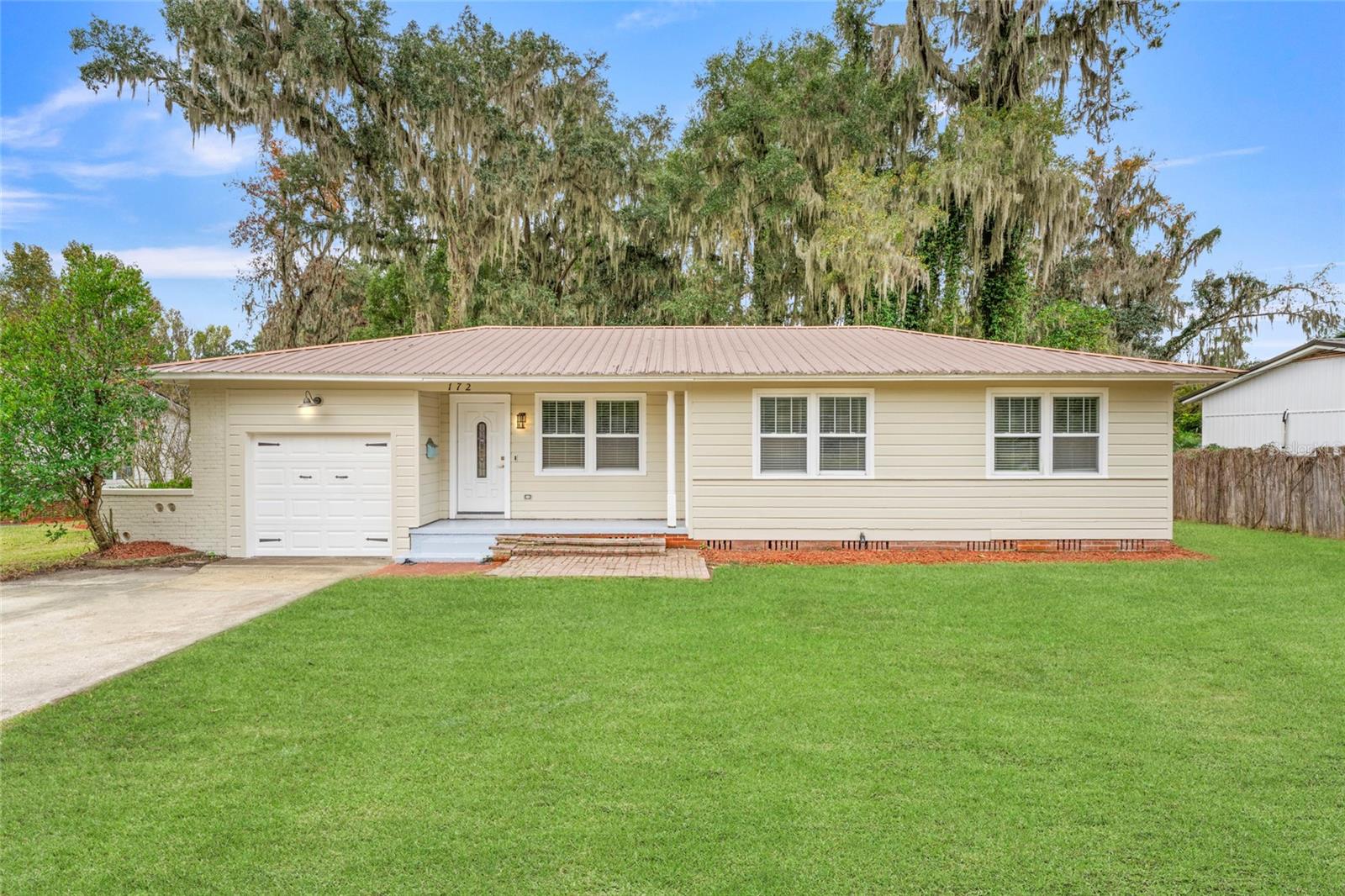 HERE IS THE HOME WITH CHARM AND AFFORDABILITY! This stunning three-bedroom, two-bath residence is boasting nearly 1,700 square feet of comfortable living space and is perfectly nestled in the Lakewood Subdivision. From the moment you walk into this little gem, you will enjoy the completely renovated and updated features it has to offer. The home greets you with classic charm, showcasing high baseboards, quaint crown molding, and beautiful hardwood floors throughout. The light and bright walls maximize natural light, leading your eye toward the inviting fireplace framed by elegant double French doors. The kitchen has been entirely updated with white wood soft-close shaker cabinets, pristine granite countertops, recessed lighting, and sparkling stainless steel appliances, creating a true chef's space. This home continues to express its luxury as you move to the Primary Suite, where the bathroom provides a true spa retreat, featuring a generous walk-in shower for two with a bench and dual shower heads, as well as a beautiful Victorian soaking tub. Practical features include an indoor laundry area with generous cabinet space, ceiling fans throughout the home, and a spacious garage. Finally, you will certainly enjoy the large, private fenced backyard. Located just minutes from nearly everything, including vibrant downtown Lake City, this home delivers effortless, updated living. Contact us today and set up your private showing.