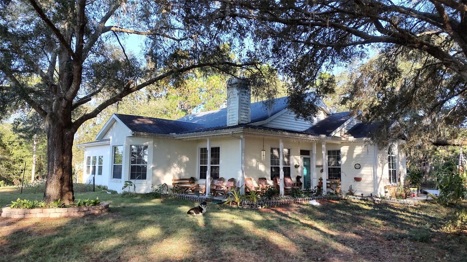 Rare opportunity to own in the established Oak Forest neighborhood. Location is close to the Hernando county line located off of US Hwy 41.   Home is located on a cul-de-sac and situated on a large lot with no HOA. Custom built block home offering 3 bedrooms and 2 bathrooms, with a 2 car garage. As you walk up to the home you are greeted by the front wraparound patio that offers scenic views of the neighboring 60 acre pasture. Entering the home you will notice the custom tile work in the foyer and beautiful Hickory hardwood floors throughout the living areas and bedrooms. Living room has a wood burning fireplace & large, lighted storage closet. Living room and separate dining areas allow for plenty of space for entertaining guests. Dining room has tray ceiling. Kitchen offers island with breakfast bar and dual sinks. Ample cabinet space with slide out shelves on the bottom cabinets. Breakfast nook is perfect for quick meals. The enclosed sun room has large windows to enjoy the country view and is equipped with a mini split AC with heat. For cooler nights warm yourself by the potbelly stove while making a hot beverage. Primary bedroom features tray ceiling, walk in closet with custom shelving. Bedroom is oversized and allows access to the garage. Primary bathroom has been updated with new vanity, toilet, shower, jacuzzi tub and flooring. Secondary bedrooms have large, lighted closets and ceiling fans. Hall bathroom has also been updated with new toilet, shower, and flooring. Washer and dryer hookups are in the garage. Water heater is new. AC condenser is two years old. Home has central vac system. Location provides easy access to major highways. Seller will help with Buyer closing costs.