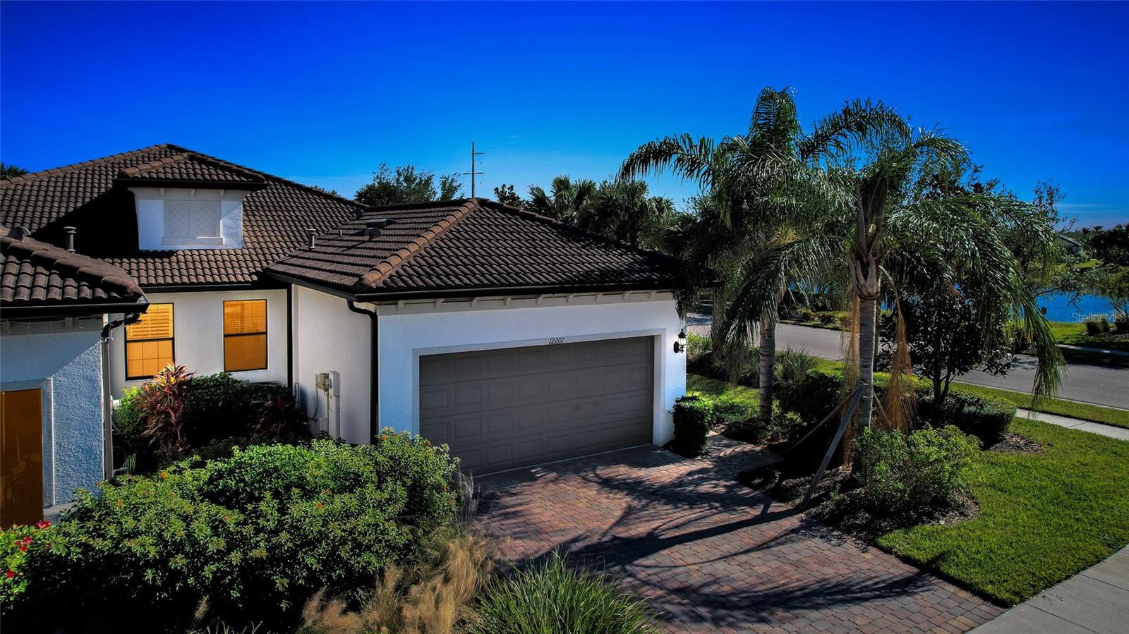 Resort-Style Living in Palmer Ranch! This move-in ready end-unit villa is light & bright with western water views.  A true 3 bedroom & 2 full baths with a 2-car garage has been meticulously maintained by the original owners. Numerous upgrades were added to the design starting with whole house Impact Glass windows & slider, 8’ doors, & additional electrical features. This move-in ready home is meticulously maintained with porcelain tile throughout the living spaces, a neutral color palate, designer lighting for a modern feel, and a gorgeous gourmet kitchen with brand new Whirlpool stainless gas stove, dishwasher & microwave.  Granite countertops with designer stone backsplash, a generous closet pantry & bar seating with pendant lighting makes this the heart-of-the-home.  A pocket door thoughtfully provides privacy to the 2nd bedroom & bath. The open floor plan flows seamlessly out onto the covered & screened lanai where Al Fresco dining, morning coffee or sunset celebrations make memories. The Hammock Preserve offers the ultimate Florida lifestyle, with maintenance-free living and no CDD extra fees.  This gated community includes a catering Clubhouse for numerous activities & gatherings, a resort-style heated lap pool & spa, fitness center, and fire pit.  Lighted Pickleball & Tennis courts along with Bocce courts provide additional opportunities & the on-site Property Manager provides peace of mind.  This pet-friendly community also provides a gated playground for your furry canines. Located in the heart of Sarasota County, with easy access to Downtown Sarasota cultural centers, the quaint Downtown Venice center, numerous well-known Gulf Coast beaches & the 20-mile Legacy Trail for biking/walking while experiencing the lush Florida landscaping.  Ready to trade your worries for Paradise?  This move-in ready 2017-built home is waiting for you!  A great investment at this new 2025 Pricing!