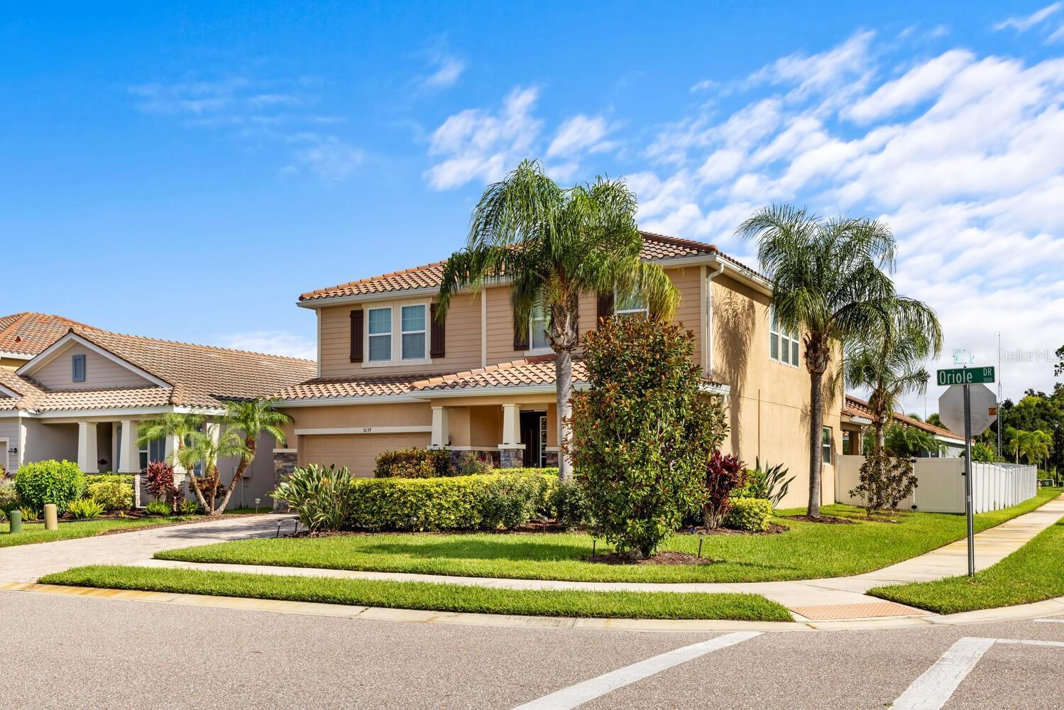 Beautifully Appointed Sarasota Home in a Prime Gated Community
Situated on a desirable corner lot within the gated community of The Soleil, this expansive two-story residence offers over 3,000 square feet of beautifully designed living space, featuring 4 bedrooms, 3 full bathrooms, and a versatile bonus loft. The charming stone elevation and brick paver front porch set the tone for the elegant interiors that follow. A grand foyer opens to a formal dining room enhanced by soaring ceilings, tile flooring, and generous picture windows that fill the space with natural light.
The heart of the home is the spacious family room, perfectly connected to a chef’s kitchen complete with granite countertops, stainless steel appliances, subway tile backsplash, solid wood cabinetry, a butler’s prep area, and a massive walk-in pantry. A guest bedroom and full bath with granite vanity and large tiled walk-in shower are conveniently located on the main floor.
Upstairs, a generous loft provides flexible living space for a game room or second family room. The luxurious primary suite features a double-door entry, private sitting area, tray ceilings, spa-like ensuite with dual vanities, soaking tub, walk-in shower, and a spacious walk-in closet with direct access to the laundry room. Two additional bedrooms and a full bath with dual sinks and tub/shower combo complete the upper level.
Outside, enjoy the privacy of a fully fenced backyard with ample space to add a pool. Residents of The Soleil enjoy premium amenities including a community pool, dog park, fitness center, bocce court, and more. Ideally located just off University Boulevard with easy access to Highway 301, Sarasota Airport, and top-tier shopping and dining.