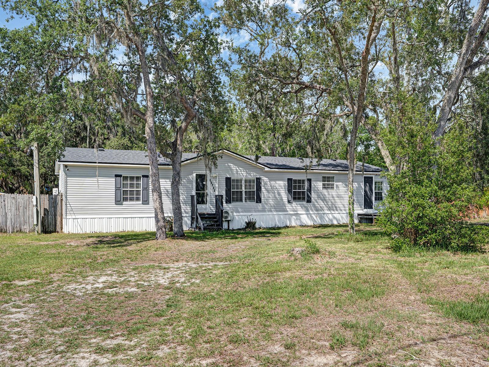 Welcome to this beautifully renovated retreat in the heart of New Port Richey! Situated on a sprawling .75-acre fully fenced lot, 12845 Casa
Bianca Dr offers the perfect blend of privacy, flexibility, and modern comfort. Conveniently located between Casa Bianca Ave and Back Bay Ave, the property features dual street access for added convenience and versatility. This move-in-ready home features 3 spacious bedrooms and 3 full bathrooms, along with a bright open-concept floor plan designed for comfortable everyday living and effortless entertaining. Recent upgrades include new flooring throughout, updated bathroom vanities, freshly painted decks and doors, and a beautifully renovated kitchen complete with stainless steel appliances, stunning countertops, and abundant cabinet space. Major system updates provide peace of mind, including a new roof and central A/C installed in 2022. In addition, each room is equipped with its own mini-split A/C unit for customizable comfort year-round. Step outside and enjoy the endless possibilities of this expansive AR-zoned property— with no HOA and no CDD restrictions. The fully fenced yard includes a new storage shed and a gated dog run, making it ideal for pet owners, outdoor enthusiasts, or anyone needing extra space for toys, hobbies, or future expansion. Located a short walk to Moon Lake Park, residents can enjoy access to a boat ramp, lakeside beach, playground, and scenic outdoor recreation. Plus, shopping, dining, and everyday conveniences are just a short drive away. Offering the charm of modern updates with the freedom of a large private lot, this exceptional property is ready to welcome you home. Schedule your private showing today!