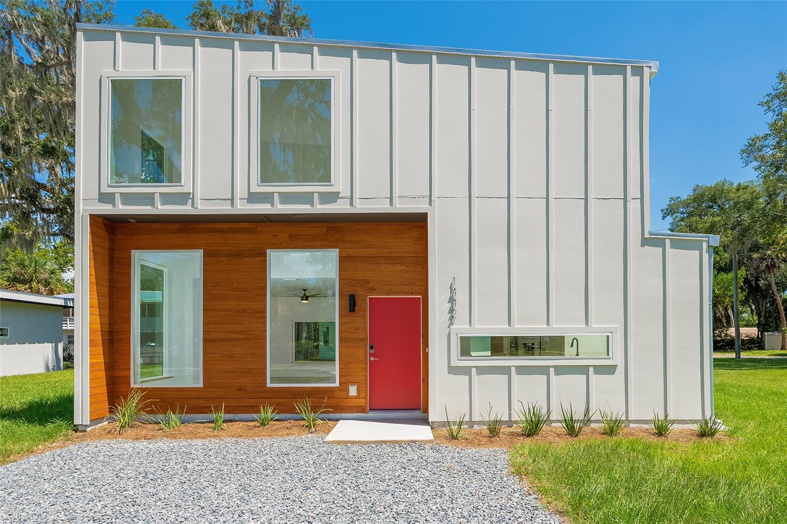 Modern new construction combined with the uniqueness of Old Florida charm in the Hammocks area of Palm Coast. Discover this quality new construction home located just West of A1A and close to Jungle Hut Beach, Bing's Landing boat ramp, local restaurants, grocery, shopping and more. Colour Homes, a local builder, has designed and built the home to capture the private natural surroundings through the large windows and expansive ceilings. Inside, the home features a clean and modern look with smooth walls and ceilings, quartz countertops, wood cabinetry with soft close hinges, upgraded LVP flooring and 2x6 exterior studs for added structural integrity. Outside, the home is designed to be low maintenance, durable and stand up to the elements with a metal roof and cementous board siding. Energy efficiency is enhanced by the spray foam insulation in the ceiling and the tankless water heater. This property would make the ideal primary home or a secondary vacation home or a desirable short term rental investment property.