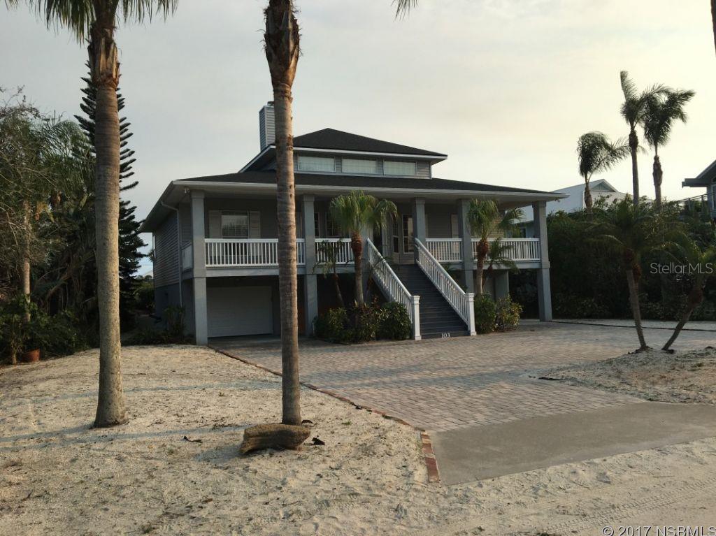 New roof, front door, and insulated garage doors!!! BEACHSIDE OLD FLORIDA STYLE With a double wide entry staircase and 7 car first floor garage with painted surface. Deep front porch leads into a grand room with built-in fireplace and stereo storage, 20 ft. ceilings, polished oak hardwoods, bleached wood accents, travertine bathrooms,  kitchen island and breakfast bar. This 3 BR, 2BA is located between the ocean walkover and river walking pier. Beautifully landscaped with minimal maintenance required. Separate RV/boat pad. Many furnishings included or negotiable. ;Water: City