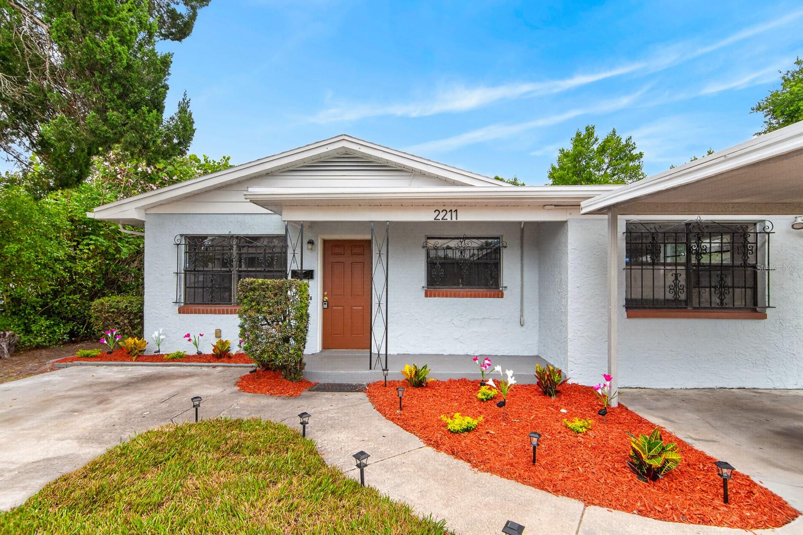 Welcome to this beautifully updated 4-bedroom, 2-bathroom home offering comfort, style, and a convenient Tampa location. Inside, you'll find brand-new luxury vinyl plank flooring throughout and a modernized interior ready for its next owner. The kitchen features gray cabinetry, laminate countertops, stainless steel appliances, and ample cabinet space, while the adjacent living and dining areas provide a functional layout for everyday living and entertaining.

The spacious primary suite includes an en-suite bathroom with a walk-in shower, while three additional bedrooms share a guest bathroom with a tub/shower combination. The laundry room is conveniently located in an attached exterior room just outside the back door.

Outside, enjoy a spacious partially fenced backyard, fresh exterior paint, two driveways, and a covered carport, providing plenty of parking and flexibility. Additional highlights include a roof approximately 7 years old, no HOA, and a desirable Flood Zone X location for added peace of mind.

Ideally situated with quick access to I-4, I-275, and the Lee Roy Selmon Expressway, this home is just minutes from Downtown Tampa, Seminole Heights, Ybor City, the Channelside Bay District, Raymond James Stadium, the Tampa Riverwalk, plus a variety of shopping, dining, and entertainment options.