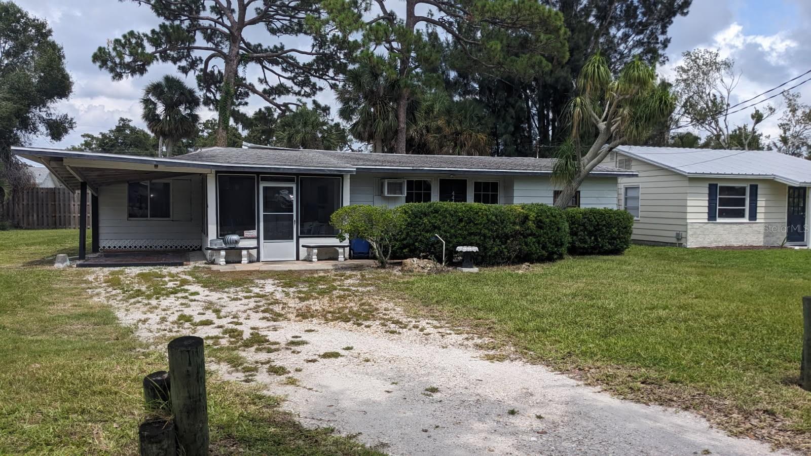 Handyman or tear down. Potential of 2 buildable lots. The carport area roof lifted in last hurricane.