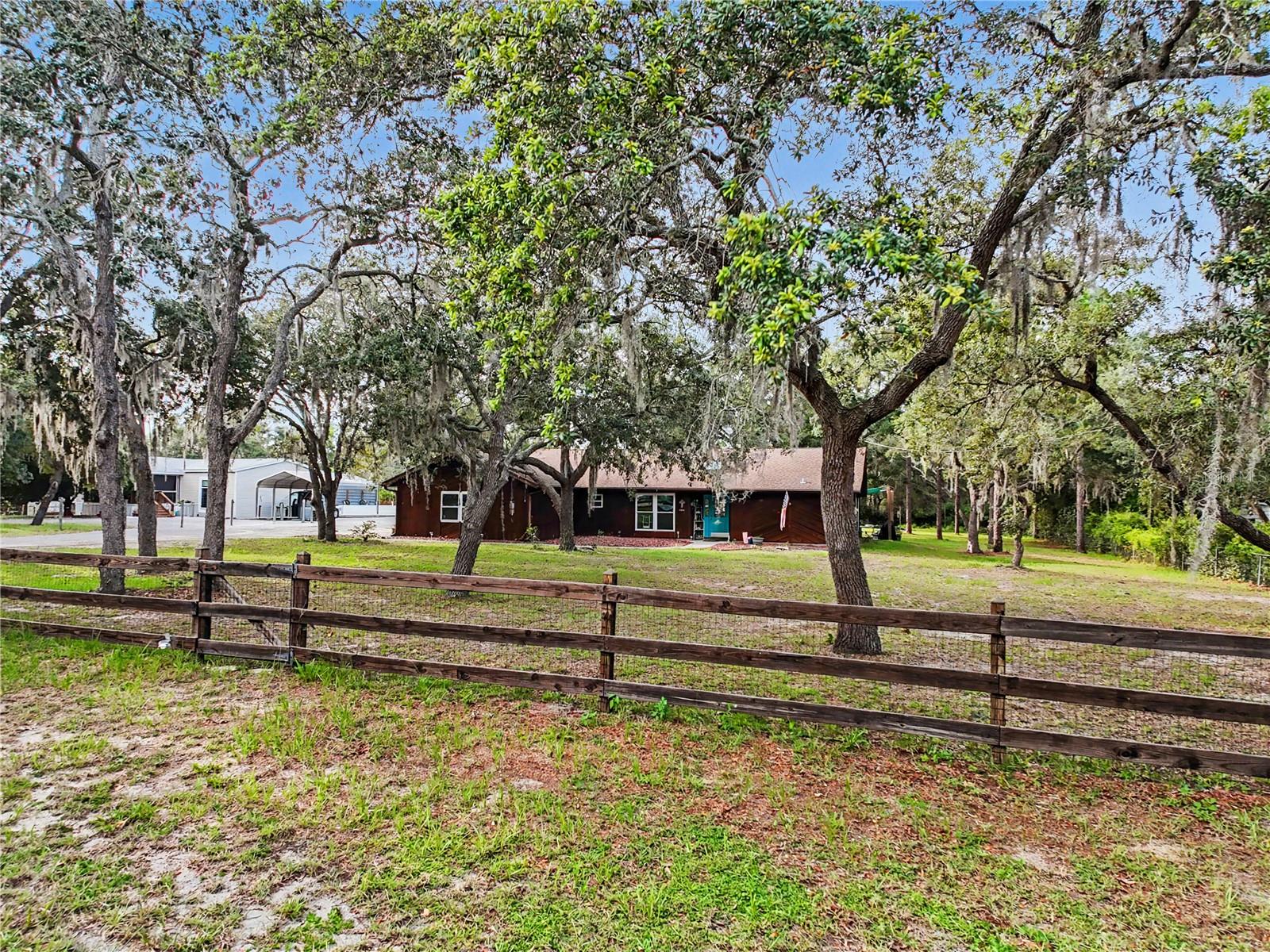 Welcome to 5253 W. Rochelle Street, Homosassa, FL! Situated on a fully fenced 1-acre lot, this well-maintained 1,728-square-foot home offers 2 bedrooms, 2 bathrooms, a dedicated office/hobby room, and a spacious 2-car garage. Enjoy peace of mind with a brand-new roof being installed prior to closing, along with major updates including 2019 windows, a 2020 water heater, a 2022 HVAC system, and a new garage door opener. Inside, you'll find an expansive great room with vaulted ceilings, spacious bedrooms, a large laundry room with pantry, and a kitchen with Corian counters and stainless steel appliances. It is a very functional floor plan designed for comfortable living with laminate, carpet and tile for flooring. A very convenient office/hobby room is right off the kitchen. The primary suite features stylish shiplap accents, a walk-in closet, and bathroom with a tiled walk-in shower and double sinks. The enclosed all-weather porch provides valuable additional living space perfect for relaxing, entertaining, or enjoying views of the property year-round. Additional highlights include skylights that bring in natural light, garage storage cabinets for organization, and a storage shed for tools and equipment. There is also an outdoor space set up like you are sitting at the beach to enjoy your morning coffee or evening cocktail. With room to spread out, modern updates already completed, and a desirable Homosassa location, this property offers the perfect combination of comfort, convenience, and country living.