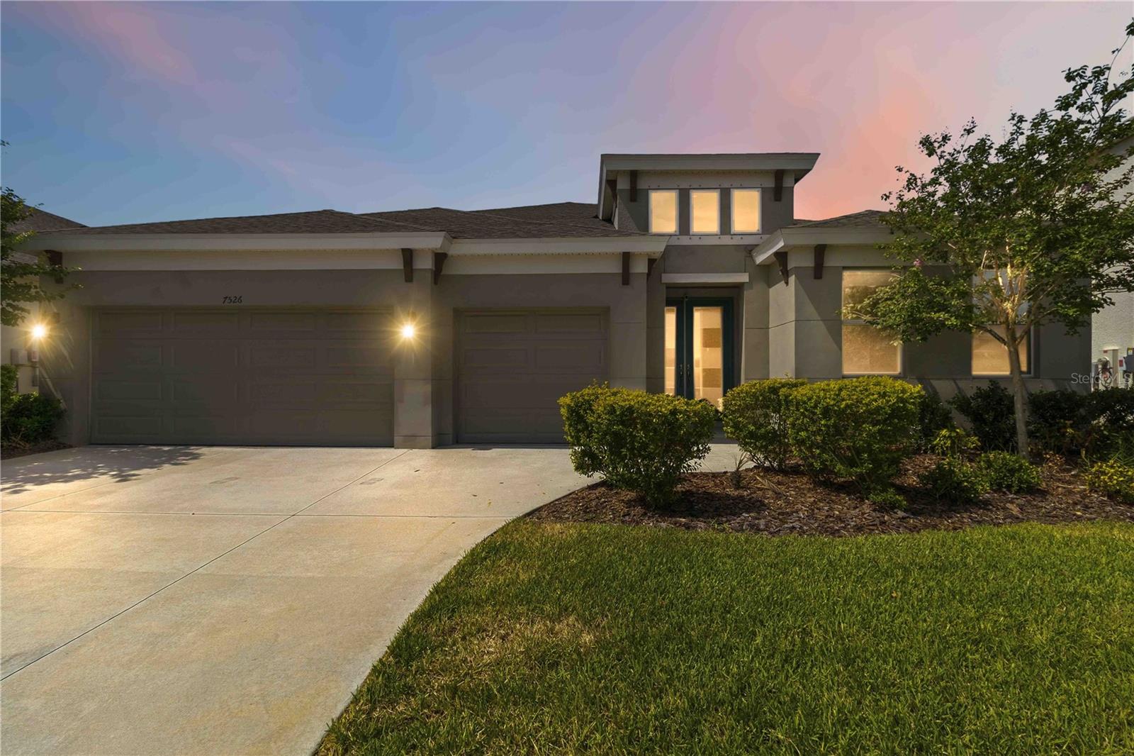 Virtually Staged. Welcome to your coastal contemporary oasis in Apollo Beach's premier master-planned community, Waterset! Located at 7526 Paradiso Dr, this spectacular 4-bedroom, 3-bathroom "Bayshore" model by Homes by WestBay perfectly blends modern luxury with a vibrant, resort-style lifestyle. From the moment you arrive, the striking curb appeal, manicured landscaping, and spacious 3-car garage set a grand tone.

Step through the elegant double-door entry into a sprawling, light-filled open concept great room featuring gorgeous LVP flooring, recessed lighting, and soaring ceilings. The open kitchen flows effortlessly with the great room boasting crisp white cabinetry, gleaming quartz countertops, a classic subway tile backsplash, stainless steel appliances with a professional hood, and an extraordinary double-island setup that is tailor-made for entertaining.

The expansive primary suite serves as a private retreat, complete with two generous walk-in closets and a spa-like ensuite bathroom featuring dual vanities, a dedicated makeup station, and a massive custom-tiled walk-in shower. Slide open the 16-foot pocket sliders to reveal an oversized, fully screened patio (24' x 32'), creating a seamless indoor-outdoor living experience.

Living in Waterset means enjoying unparalleled HOA amenities, including multiple resort-style swimming pools, a water splash pad, fitness centers, tennis, basketball, and pickleball courts, dog parks, playgrounds, a community café, and miles of scenic walking trails. Commuting is a breeze with quick access to I-75 via the Paseo Al Mar interchange or Big Bend Road, placing downtown Tampa, MacDill AFB, Brandon, and the gulf beaches just a short drive away. Don't miss your chance to own a slice of paradise!