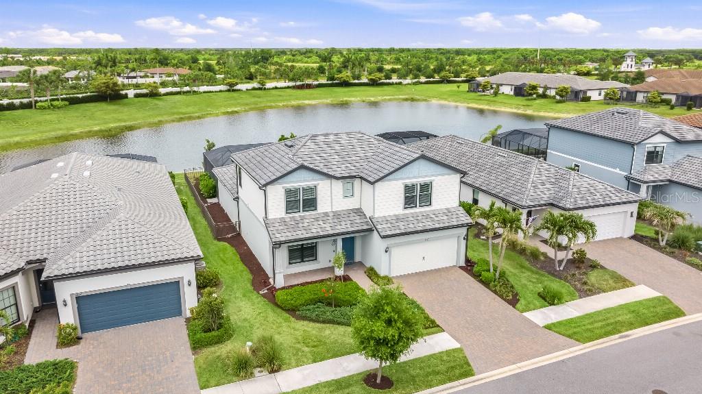 Welcome Home to Your Private Waterfront Oasis in Talon Preserve on Palmer Ranch This stunning Whitestone model home is the ultimate entertaining retreat, filled with endless upgrades and situated on a premium lot with breathtaking pond views and no homes behind you. Offering 5 bedrooms, 4 bathrooms, and 2,890 square feet, this beautiful home has no CDD fees and is not located in a flood zone. It is conveniently located close to the amenities center.
The spacious first floor features a primary owner’s suite with a luxurious bathroom featuring dual sinks, a walk-in shower, and a sunken tub, plus a generous walk-in closet. It also includes a second bedroom with a built-in Murphy bed and a full bathroom — ideal for guests, multi-generational living, or a home office. Upstairs, three generously sized bedrooms, two full bathrooms, and a large loft provide excellent flexible space perfect for a game room, media room, or second living area.
Step outside to your private backyard paradise featuring a custom oversized heated pool and spa with both gas and electric heaters for quick warm-ups, plus a fully equipped custom outdoor kitchen with refrigerator, sink, grill, side burner, and hood. The pool area includes a fence wrapped around the pool cage — perfect for year-round entertaining and Florida living at its finest.
Impressive upgrades include:
• Hurricane impact windows
• 8-foot interior doors
• Energy efficient tankless water heater
• 4-foot garage extension with epoxy flooring
• Dual electric vehicle charging ports
• No carpet throughout
• New lighting and ceiling fans
• Updated countertops and cabinetry
• Built-in dog door
• Whole-home EcoWater softener and refiner system
• EcoWater reverse osmosis system in the kitchen
• Built-in Murphy bed in the second first-floor bedroom
Talon Preserve is a gated, maintenance-free resort-style community on Palmer Ranch with direct access to the Legacy Trail. Enjoy premier amenities including a restaurant/bar, community pool and hot tub, wellness/spa services, fire pit, sports courts, arcade, nature walking trails, and much more.
This rare combination of luxury upgrades, private pond-front living, and an unbeatable location makes this home truly special. Don’t miss your opportunity — schedule a private showing today!
some photos are virtually staged.