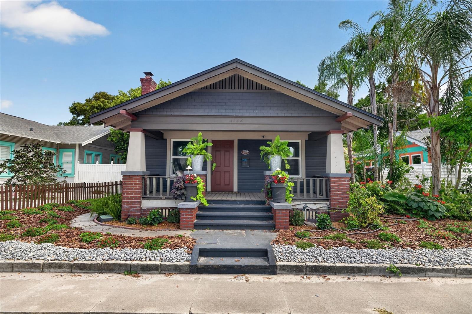 Virtually Staged. Welcome to the epitome of St. Pete living! This 1925 Historic Kenwood craftsman bungalow seamlessly pairs vintage soul with modern luxury. From the moment you step inside, the home’s rich history shines through its classic architectural trim, beautifully preserved original hardwood floors, and a stunning working fireplace that sets the perfect mood for cozy winter evenings. Designed with everyday life in mind, the smart layout features a bright, sweeping open-concept living and dining area built for entertaining, while keeping both bedrooms and bathrooms completely closed off to ensure quiet privacy. The primary suite serves as your own personal sanctuary, highlighted by a massive, fully transformed en-suite bath and shower that rivals a luxury spa, plus the ultimate convenience of a dedicated indoor laundry setup. Outside, the property boasts an impressively sized backyard that offers a generous amount of green space, creating a vibrant, sun-soaked lawn complete with your own personal fruit orchard of Avocado, Dwarf Mulberry, and Dwarf Mango trees. Location-wise, it doesn't get better than this. Nestled in a wonderfully tight-knit, highly walkable community, you can easily stroll for a day spent on Central Avenue or jump onto I-275 for a seamless commute to Tampa. This perfect blend of historic charm and modern luxury is ready for its next chapter. Schedule your private showing today and make this Kenwood oasis yours!