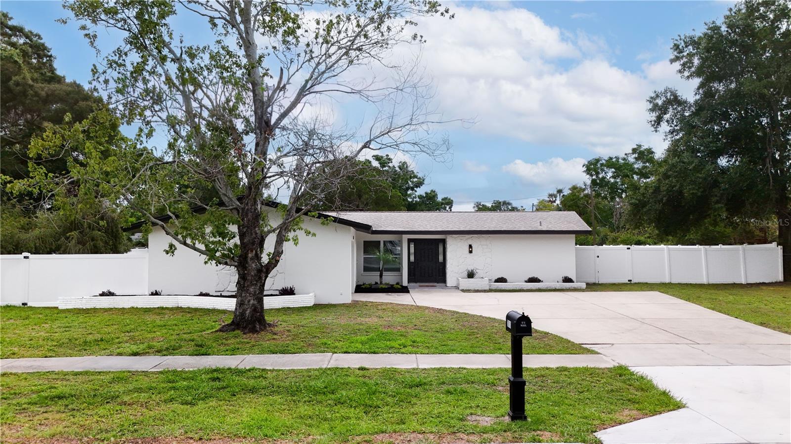 More than just a home, this property offers the space, updates, and flexibility that are becoming increasingly difficult to find in Pinellas County. This beautifully updated 3-bedroom, 2-bath, 1-car garage home sits on an impressive oversized 17,000+ sq. ft. (.39-acre) fully fenced lot in the heart of Pinellas Park. From the moment you step inside, you'll appreciate the fresh interior paint, luxury vinyl plank flooring throughout the common areas, and the bright open-concept layout that seamlessly connects the living room, family room, dining area, and kitchen. The stunning chef's kitchen is the centerpiece of the home, featuring quartz stone countertops, custom cabinetry, stainless steel appliances, a gorgeous tile backsplash, and a large island with a farmhouse sink. Just off the kitchen, the dining area offers a custom dry bar complete with additional cabinetry and a wine fridge, creating the ideal space for hosting guests. The spacious primary suite features a walk-in closet, a beautifully updated en-suite bathroom with dual vanities and a tiled walk-in shower, plus a versatile bonus room perfect for a home office, dressing room, nursery, fitness space, or hobby room. Additional highlights include an indoor laundry room and an expansive backyard with endless possibilities for outdoor living, recreation, or a future addition or pool. Conveniently located near Freedom Lake Park, Sawgrass Lake Park, and just a short drive from the award-winning Gulf beaches, vibrant downtown St. Petersburg, shopping, dining, entertainment, and major commuter routes. Opportunities to own a move-in-ready home with this much land are few and far between, schedule your private showing today before it's gone!