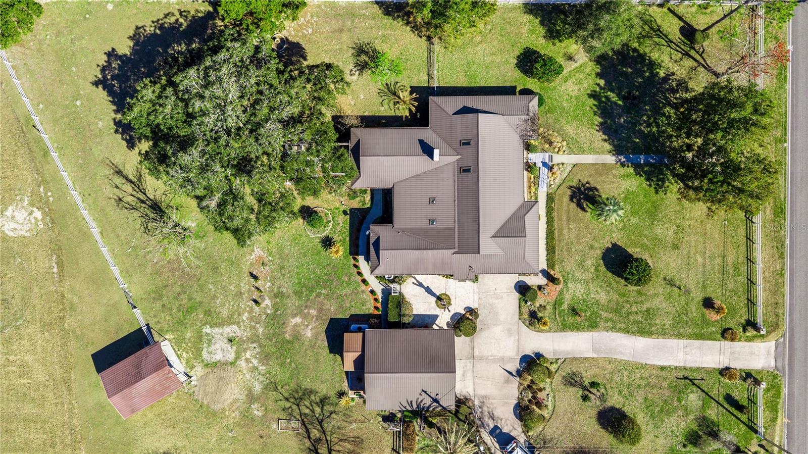 Hard to find location PAVED ROAD FRONTAGE 2 private acres with Fruit trees and beautiful mature landscaping SURROUNDED by larger parcels makes this setting tranquil but with a short drive to Shopping, restaurants and more. Do not follow gps property is on paved road!
Updated Classic Brick home with nearly new metal roof for easy maintenance and low utility bills.
Stunning kitchen with granite counters and upgraded cabinets, center aisle .
.
Summer Kitchen and workshop
Whole house generator 

Huge great room with fireplace  plus enclosed sun room with views of nature and sometimes wild life.