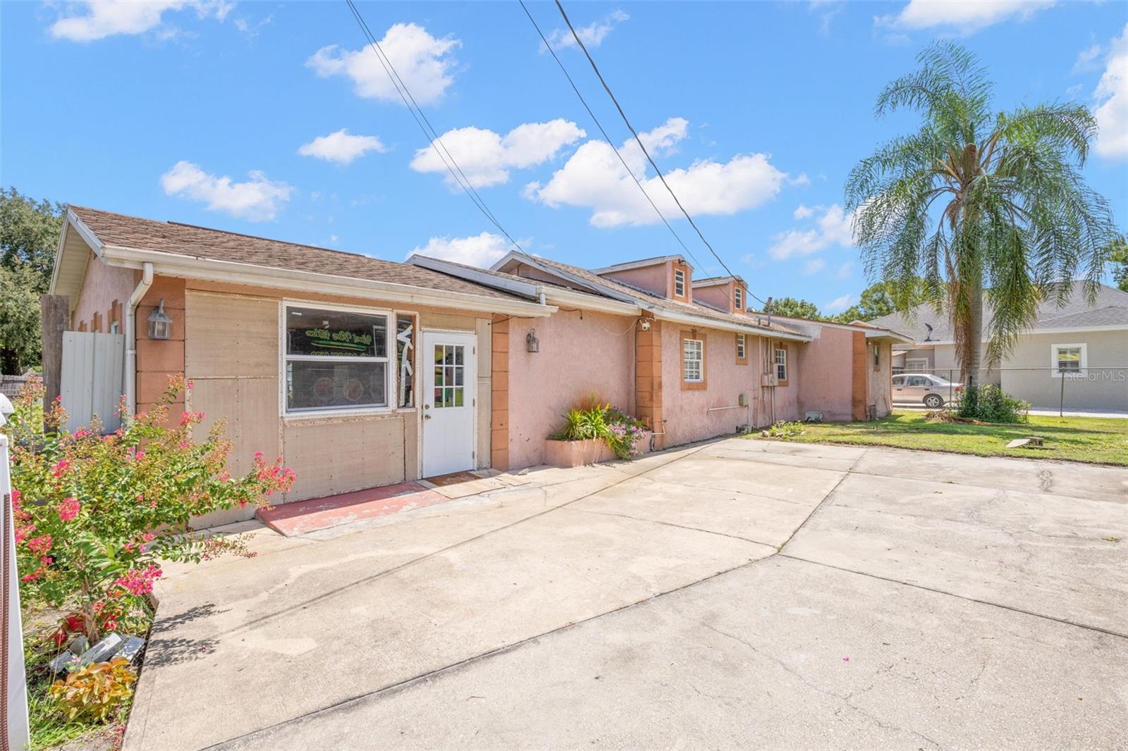 Welcome to a home where space, character, and opportunity come together. Nestled on one of the largest fully fenced corner lots in the neighborhood—over a quarter acre with no HOA—this spacious 2,294+ square-foot ranch-style residence offers a lifestyle that's becoming increasingly difficult to find. From the moment you arrive, you'll appreciate the inviting over-sized front porch and expansive covered carport, setting the tone for a home designed for comfortable Florida living. Inside, the heart of the home is an impressive over-sized great room with abundant space for entertaining, gathering with family, or simply relaxing. The generous walk-in kitchen provides an excellent footprint for future updates while offering plenty of workspace and storage. The home's relaxed architectural style evokes a warm Caribbean-inspired atmosphere, creating a unique sense of comfort and charm that sets it apart from the ordinary. Large living spaces, a functional floor plan, and abundant natural light make this home feel welcoming from the moment you step inside. Outside, the over-sized fenced yard provides endless possibilities—whether you envision outdoor entertaining, gardening, room for pets to play, or simply enjoying the privacy and freedom that comes with owning one of the neighborhood's premier lots. This one-owner home has been well loved over the years and is ready for its next chapter. While it would benefit from cosmetic updates and the existing air-conditioning system is currently not operational, it presents an outstanding opportunity for buyers to personalize the home to their own style while building equity. If you've been searching for a property that offers generous living space, a sizable home site, timeless character, and the freedom of no HOA, this is a rare opportunity you won't want to miss. Contact the listing agent today to schedule your private showing today and imagine the possibilities.