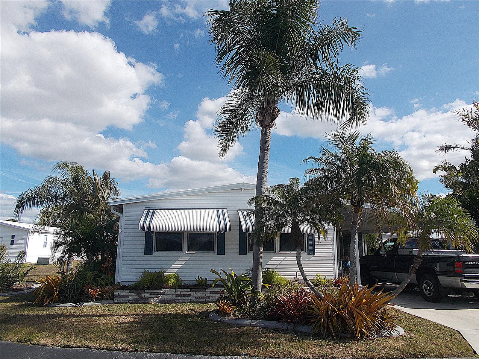 Your perfect escape from the cold!  This well cared for double-wide mobile in Sandalwood Park offers 2 bedrooms and 2 full bathrooms and has been used as a seasonal residence for the last 25+ years.  You'll find a brand new carport, the A/C was replaced in 2024, new electrical panel in 2022 and the entire home was re-piped with PVC in 2008.  If you're a lover of lush plantings and foliage, you are going to absolutely LOVE what this seller has transformed the mobile's surroundings into!  Being sold "turn-key furnished", all you need is your personal belongings to begin enjoying the Florida sunshine and all that Sandalwood Park has to offer!  From potluck dinners to exercise classes and seasonal concerts, you'll be as busy as you want to be.  Relax in the heated (and cooled) large pool or join a shuffleboard team and show off your skills.  Perhaps happy hour on the patio by the pool is more your vibe.  Whichever the case, you're bound to make new friends!  Your furry family members are also welcome!  The location of Sandalwood Park just can't be beat!  You'll find shopping, restaurants and medical offices just a short distance away.  Venice Beach is only 4 miles away and Sarasota Memorial Hospital (Venice campus) is only 5 miles away.  Don't miss this opportunity to begin living the Florida lifestyle you deserve!  Make your appointment to see this mobile today and make it yours. . . . before someone else does!