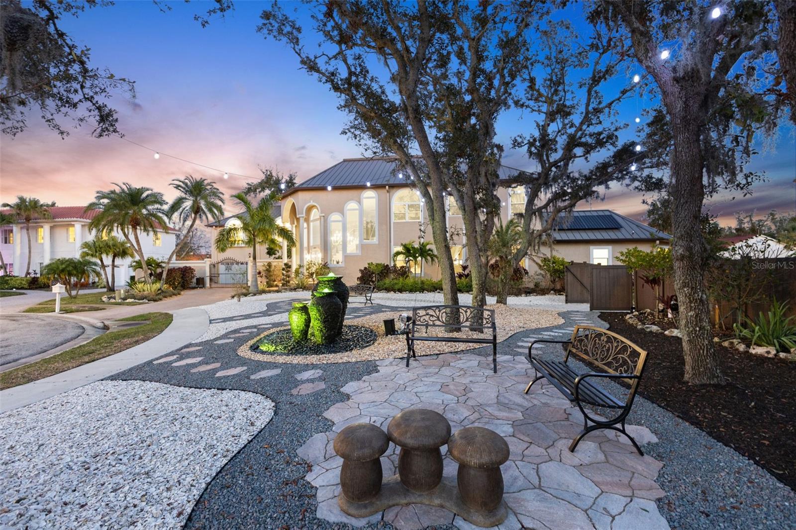 Showing for Back Up. Massive Price Reduction! Where luxury meets the savvy buyer. An extraordinary opportunity where luxury, paradise, prestige, and privacy unite. With over $1.2 MILLION IN UPGRADES SINCE 2022, this remarkable estate delivers resort-style living, energy independence, and multigenerational flexibility in one of Clearwater’s most exclusive communities.

Set on 1.11 high-and-dry acres at the end of a quiet cul-de-sac within the private, 11-home gated neighborhood of Landmark Reserve, this home showcases the highest quality systems and finishes. A bronze GALVALUME STANDING SEAM METAL ROOF (2022), FULLY PAID 40.8 kW SOLAR SYSTEM WITH 125 SUNPOWER PANELS AND FIVE BATTERY BACKUPS, FIVE HVAC SYSTEMS (2022), and PREMIUM PGT HURRICANE-RATED IMPACT WINDOWS AND GARAGE DOORS ($350K UPGRADE IN 2023) ensure unmatched durability and efficiency. Energy bills average just $35/month, supported by a Level 2 EV charger, water softener, and private irrigation well.

Inside, elegance is expressed through HARDWOOD and MARBLE tile flooring, COFFERED ceilings, custom millwork, and a sweeping imperial staircase beneath a statement CRYSTAL chandelier. The gourmet kitchen is equipped with a WOLF 6-burner GAS cooktop, DUAL WOLF convection ovens, SUB-ZERO refrigerator (2023), SOLID SURFACE counters, oversized island, and custom cabinetry.

The main-floor primary suite offers spa-level luxury with a FRAMELESS WALK-IN shower featuring DUAL RAIN HEADS, soaking tub, double vanity, and direct outdoor access. A FULLY RENOVATED GUEST APARTMENT (2023) with its own kitchen, breakfast nook, living area, and laundry provides private space for guests, in-laws, or live-in support. Three ways to access the apartment. 

The outdoor setting is nothing short of a private resort: a HEATED SALTWATER POOL AND SPA (2023) with TRAVERTINE decking, SUN SHELF, LED lighting, water features, and a BOULDER ROCK FOUNTAIN. A TRANQUIL POND with a color-changing fountain is maintained by the HOA. The COVERED OUTDOOR KITCHEN (2023) features a natural stone bar, gas grill, wet bar, built-in seating, and a private pool bath.

An ADJACENT LOT IS INCLUDED, offering potential for an additional garage, guesthouse, or resale opportunity for a minimum 5,000 sq. ft. home.

Minutes from Clearwater Beach, Safety Harbor, Dunedin, airports, shopping, and fine dining, this estate offers an unmatched Florida lifestyle.

A rare chance to acquire a MODERN, TURN-KEY LUXURY ESTATE with CRAFTSMANSHIP, ENERGY EFFICIENCY, and PRIVACY at its core. Properties of this caliber are seldom available—act quickly to make it yours. Don’t miss this rare opportunity. Be sure to check out the stunning social media reel attached.