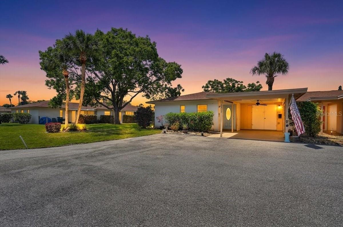 COZY & CONVENIENT FLORIDA LIVING WITH AN AFFORDABLE PRICETAG! Tucked within one of West Bradenton's most beloved and established communities, this charming 2 BEDROOM, 1 BATHROOM END UNIT villa offers an exceptional opportunity to embrace the relaxed Florida lifestyle you deserve. Perfect as a full-time residence or seasonal retreat, this smart investment allows you to enjoy all that the Gulf Coast has to offer without spending a fortune. The home's thoughtful floor plan maximizes usable space without sacrificing comfort. The kitchen has both an outside window view and a pass-through to the dining/living room area, great cabinet storage and a nearby closet that could double as a pantry if desired. The dining area offers a cozy eating space complete with a glorious view of the lush trees and green space at the back. The home has a welcoming open feel with plenty of space for a variety of furniture arrangements. There are two bedrooms each with large closets and easy access to the updated bathroom with tiled shower big enough for seating. Tile and laminate flooring throughout for easy cleaning. The spacious lanai offers tranquil scenery and plenty of seating areas both screened in or on a separate concrete pad area ideal for grilling. The unit has an assigned covered carport (freshly painted) and private exterior storage closet giving you convenience and protection year round. The home is NOT IN A FLOOD ZONE, meaning no flood insurance required. The Oakwood Villas community truly enhances the living experience, offering a large pool, shuffleboard courts, table tennis, billiard table, coin laundry, a clubhouse for friendly gatherings, and excellent walkability. Beyond the community, the area's finest offerings are easily accessible. Whether you prefer short drives to some of the world's most renown beaches, or want to spend sunny days strolling downtown Bradenton's Riverwalk, with its open green spaces, community amenities  and picturesque river views, you're close proximity to Manatee and Sarasota County attractions (plus and airport) make travelling fun and easy. From every variety of dining, shopping abundance, indoor and outdoor entertainment options, to major medical facilities...it's all nearby. Enjoy the privacy and affordability that this charming end unit has to offer  and schedule your tour today!