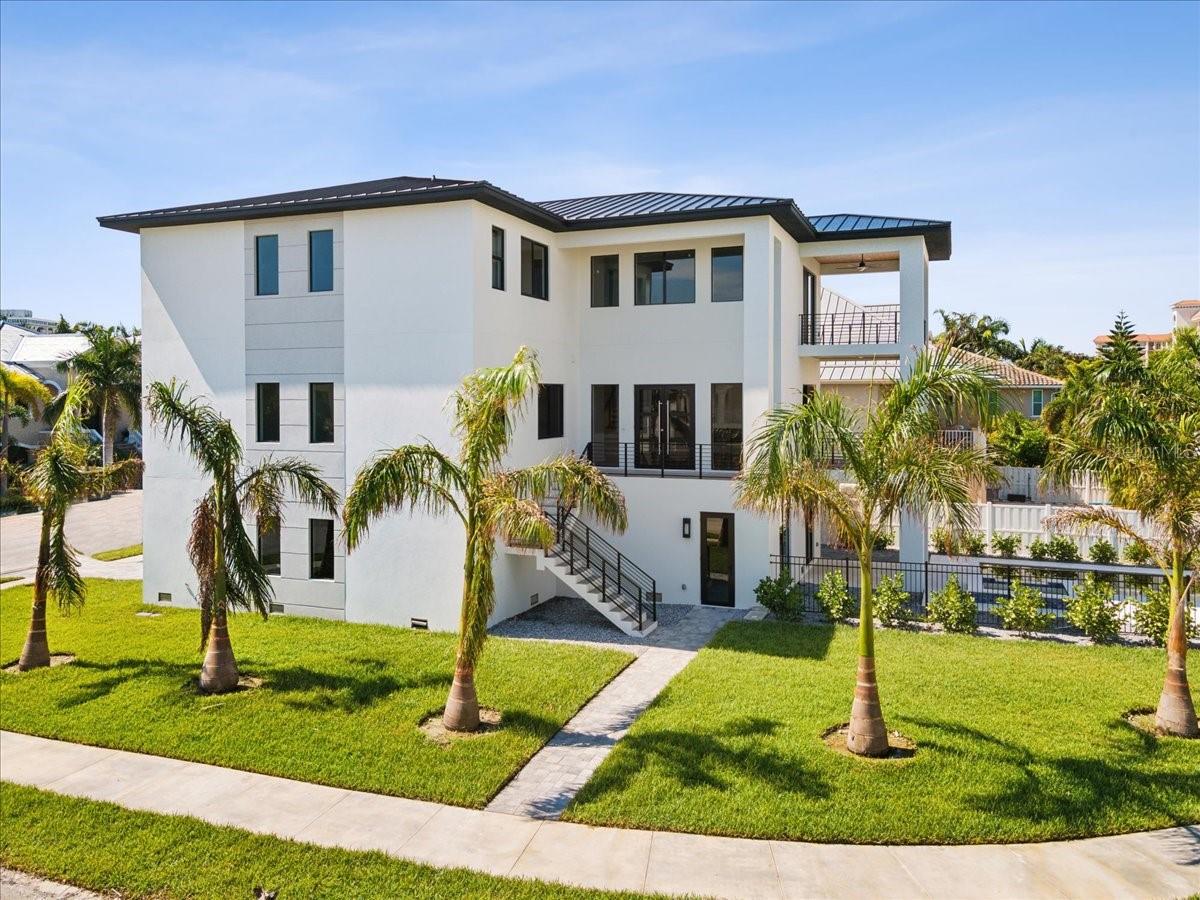 One or more photo(s) has been virtually staged. OWNER FINANCING AVAILABLE! A rare opportunity! Discover your dream home in the exclusive Redington Shores Yacht and Tennis Club! This magnificent contemporary residence features four spacious bedrooms, each with its own ensuite bathroom. The expansive kitchen is a culinary haven, equipped with Wolf appliances, and a striking island, while the airy large living room, is perfect for entertaining.

Enjoy seamless access to all levels of the home with a convenient elevator. Additional features include a spacious loft, a generous laundry room, a large storage area, walk-in closets in every bedroom, and a well-sized pantry.

Embrace outdoor living on the expansive porch and patios, and unwind in the inviting heated pool with a hot tub. For those who love boating, a boat dock is available at an additional cost. The property also includes a five-car garage, providing ample parking and storage solutions.

Located within a secure, 24-hour guard-gated community, residents enjoy access to tennis courts, a community pool, and a clubhouse complete with a fitness center and an area for your meetings. This exquisite home.  Schedule your viewing today!