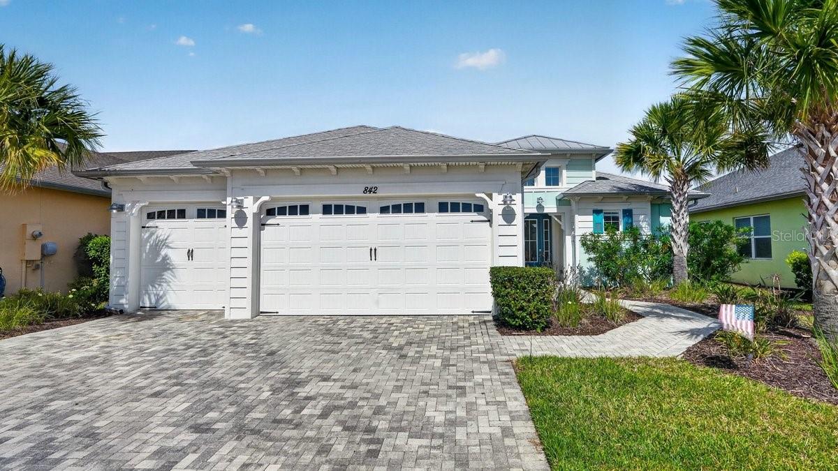 Welcome to a home where comfort, space, and lifestyle come together in the heart of Latitude Margaritaville. Built in 2019, this beautifully designed 2-bedroom, 2.5-bath home offers 2,300 square feet of living space, a flexible den that can easily become a third bedroom with the addition of a closet, and an incredible 1,300+ square foot screened lanai overlooking the water.

A paved driveway and walkway lead to the covered front porch, where you'll step inside to a bright foyer filled with natural light from the expansive lanai beyond. The thoughtfully designed floor plan flows effortlessly, beginning with the versatile den before opening into the spacious living room, where large sliders create a seamless connection to the outdoor living space.

The designated dining room is perfectly positioned for entertaining while remaining connected to the main living area. Beyond it, the kitchen serves as the heart of the home with a breakfast nook overlooking the water and direct access to the lanai. Just beyond the kitchen, the family room is surrounded by windows and sliders, filling the space with natural light and creating another comfortable place to relax or gather with guests.

The private primary suite offers peaceful water views, lanai access, two walk-in closets, and an en-suite bathroom complete with dual vanities, a soaking tub, walk-in shower, and private water closet. On the opposite side of the home, the split-bedroom layout provides privacy for guests, with the second bedroom featuring its own en-suite bathroom and walk-in shower. A convenient half bath is located near the garage for visitors.

Luxury vinyl plank flooring runs throughout the home, while practical upgrades such as a water softener system, generator hookup, and oversized three-car garage provide added comfort and peace of mind. Nearly every main living space—including the primary bedroom, living room, kitchen, breakfast nook, and family room—enjoys tranquil partial water views.

The true centerpiece of the home is the expansive screened lanai. With over 1,300 square feet of outdoor living space, it's ideal for entertaining, dining outdoors, or simply enjoying the peaceful waterfront setting.

Life at Latitude Margaritaville extends far beyond the home itself. This gated 55+ community offers a resort-style lifestyle with golf cart paths leading throughout the neighborhood and even to nearby Publix, restaurants, shopping, and everyday conveniences. Residents enjoy a vibrant Town Square featuring restaurants, live entertainment, a theater, arts and crafts studios, a pet spa, and a Hangar workshop. The community also offers a state-of-the-art fitness center with a spin room, weight room, aerobics studio, cardio equipment, indoor lap pool, and whirlpool spa, along with resort-style pools, cabanas, tiki huts, pickleball, tennis, bocce, walking trails, a dog park, countless clubs and social events, and a private beach club with shuttle service.

Conveniently located just minutes from I-95, you're within easy reach of airports, beaches, and world-famous attractions, yet everything you need is right here. This isn't just a beautiful home—it's an opportunity to embrace the relaxed, active lifestyle that makes Latitude Margaritaville one of the area's most sought-after communities.