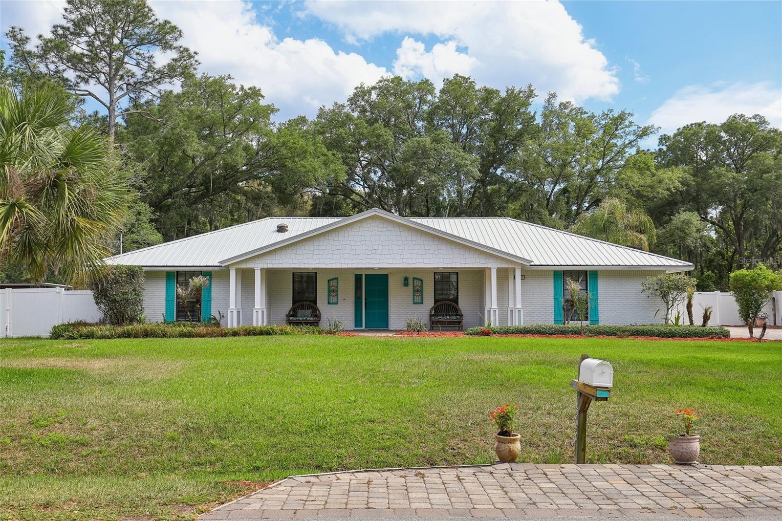 Featuring a screened-in pool, expansive outdoor living, and rare RV parking, this beautifully updated coastal-style ranch estate is perfectly positioned on a private .72-acre homesite in the desirable Fruit Cove Forest community of St. Johns County. Tucked away in a quiet, wooded setting, this property offers the ultimate blend of privacy and lifestyle--while still being just minutes from top-rated schools, shopping, and dining. Inside, you're welcomed by soaring vaulted ceilings and updated LVP flooring, creating a bright, open atmosphere throughout. The spacious layout is designed for both comfort and entertaining, featuring oversized living areas, a cozy fireplace, and a flexible floor plan with 3 bedrooms plus a dedicated office (ideal as a 4th bedroom). Step outside to your private backyard retreat, where the screened-in pool and lanai invite year-round relaxation.

The equipped built-in grill and bar sets the tone for effortless entertaining overlooking the pool, while a charming gazebo with fireplace creates the perfect setting for evenings under the stars. Additional highlights include a dedicated RV parking, a rare find in this area, detached workshop/garage for hobbies or storage, separate shed for lawn equipment or gardening, expansive pavered outdoor living spaces. Extra-large rooms offering flexibility and comfort. Located in the sought-after Fruit Cove area, known for its spacious homesites and natural surroundings, this property delivers a true Old Florida lifestyle experience.