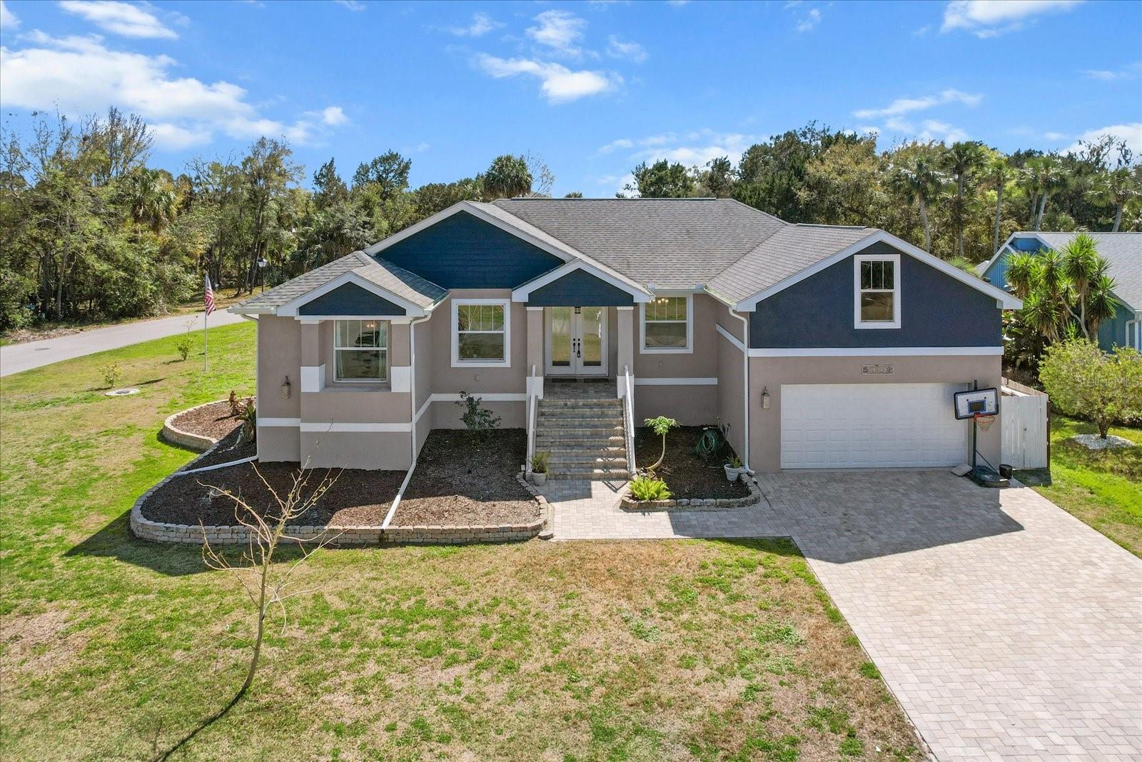 Price REDUCED! Wait till you see this beautiful elevated home on the water with a gorgeous pool! Immaculate 3,000+ sq ft waterfront property, offering modern luxury in an unbeatable location in the sought-after community of Riverhaven Village. This home features a versatile secondary living suite complete with a private bedroom, comfortable sitting area, full bathroom, and generous walk-in closets. This flexible space is ideal as a guest suite, hosting extended family, accommodating multi-generational living arrangements or creating the perfect work-from-home retreat for today's remote professionals. The open floor plan enhances the flow of natural light, with sliding doors from multiple rooms that open out to a screened-in pool and spillover spa – ideal for relaxing, entertaining, or enjoying the peaceful surroundings. The home also boasts over 9-foot ceilings throughout, adding to its spacious and airy feel. This golf cart-friendly community offers direct waterfront access in your backyard, with just a short boat ride to the Homosassa River, leading directly out to the Gulf. Living here, you'll be just moments away from swimming with the manatees, snorkeling in the scallop grounds, fishing the famous flats, and kayaking in serene waters. Enjoy the Florida lifestyle with numerous nearby waterfront tiki bars and restaurants, easily accessible by boat or golf cart. Whether you’re out on the water, relaxing by the pool, or enjoying the local attractions, this home offers the perfect setting for ultimate waterfront living. Built above base flood elevation, this home is high and dry! Flood insurance only $1457 per YEAR, offering peace of mind alongside luxury living, this home is truly the best of all worlds.