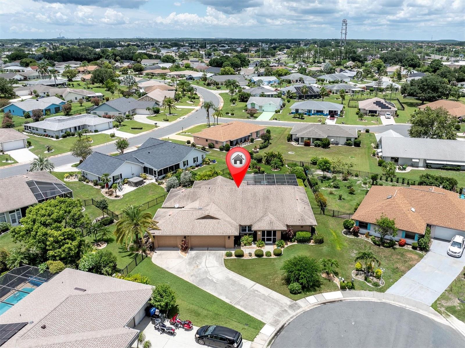 55+ resort-style living at Sun City Center - ranked #1 retirement town in the US! 
Well-maintained POOL HOME located at the end of a low traffic cul-de-sac in St Andrews Estates. This 3 bedroom, 2 bathroom and 3 CAR GARAGE home has 2400 sq ft of living space! Enter through the front door into the living room with pocket sliding glass doors, merging the interior and exterior spaces together. Enjoy peaceful relaxation in your personal oasis - a large covered patio, with wet bar, screened-in private pool with built in spa. Lush landscaping and palm trees in the fenced backyard add to the tranquility of this property. 
To the left of the front door is the dining area, currently used as an additional seating area.
Enter into a spacious primary suite with a sliding glass door for private access to the lanai and pool. The recently remodeled ensuite bath has double sinks and an oversized shower with built-in seating that is wheelchair accessible. 

The kitchen boasts beautiful granite counter tops, a breakfast bar and pantry. Just off the kitchen is the cozy family room - a great space for enjoying your favorite movies! Pocket sliding glass doors create a seamless space between the family room and lanai for quick pool access! 

Split floor plan for privacy! There are two additional bedrooms with an updated full bath located in-between. The second bedroom toward the back of the home is large enough to accommodate a king size bed. The versatile third bedroom (closest to the laundry room) was remodeled adding sq ftg – great as a bedroom with a seating area, office or use to your own personal taste. 

MANY UPGRADES: dimmer electrical switches throughout the home, all interior doors updated, all sliding glass doors have new rollers so glide easily, all lights & ceiling fans have been updated, walls have been re-textured to a knock-down finish, newer exterior paint, newer front door, garage addition (9/2007) - 3rd stall added, additional sq ftg 3rd bedroom (3/2008), new roof (2014), new water heater (2021), new pool heater (2021), new front door (2021), new AC (2024). *Water softener is leased* *Electric hurricane shutters on lanai*

No CDD Fees! Not in a flood zone! In this premier retirement community you’ll find many amenities and activities. At Sun City Amenity Center enjoy the pool, fitness center, lawn bowling, tennis courts, yoga center and more. Over 50 classes to choose from! There’s even a pickle ball court at the SCC Community Hall. Close to Tampa and Sarasota with easy access to beautiful gulf coast beaches, restaurants, shopping and airports! Enjoy the Florida lifestyle in this wonderful 55+ community!!
