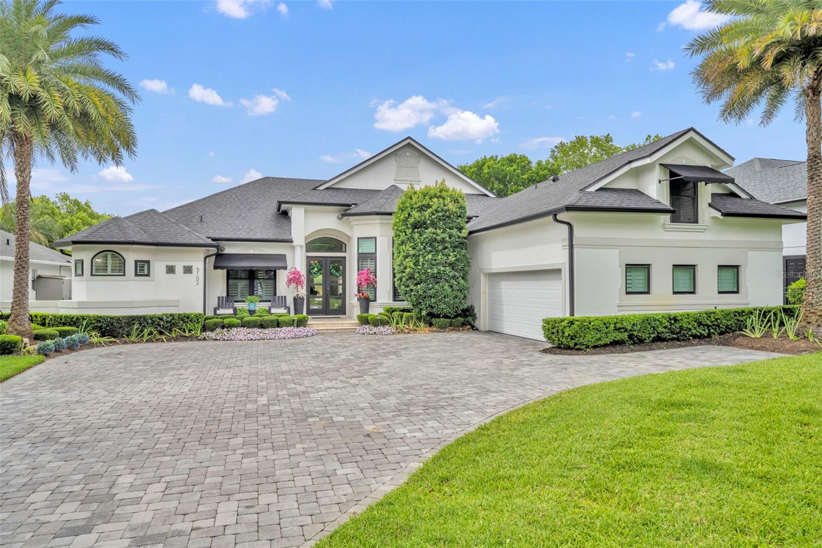 Welcome to your lakefront oasis in the gated Lake Hill Woods community! This fully updated home blends contemporary design with luxury finishes and top of the line detail in every room. This spacious home has 5 bedrooms, 5 full bathrooms, one half bathroom, plus an office and media / theater room. The ground level primary bedroom suite features lots of space, a view to the pool patio and lake, and the en-suite bathroom of your dreams. Dual vanities, a large soaking tub, and a large shower with a rain shower feature and multiple shower fixtures. The remodeled kitchen is a chefs dream with a large kitchen island, WOLF gas range, and a walk in pantry. Head through the new slider doors to the covered lanai patio overlooking the infinity edge pool and hot tub. Enjoy the private lake views with a fully fenced backyard, and a path to your own private dock with a lift and seating area. Fully remodeled in 2019 including new flooring, baseboards, window shutters, and doors throughout the home, remodeled bathrooms and kitchen, new paver driveway, completely redesigned pool patio with tile, pool resurfaced, newly re-built dock with lift. Brand new roof and gutters in 2022. Schedule to see it today!