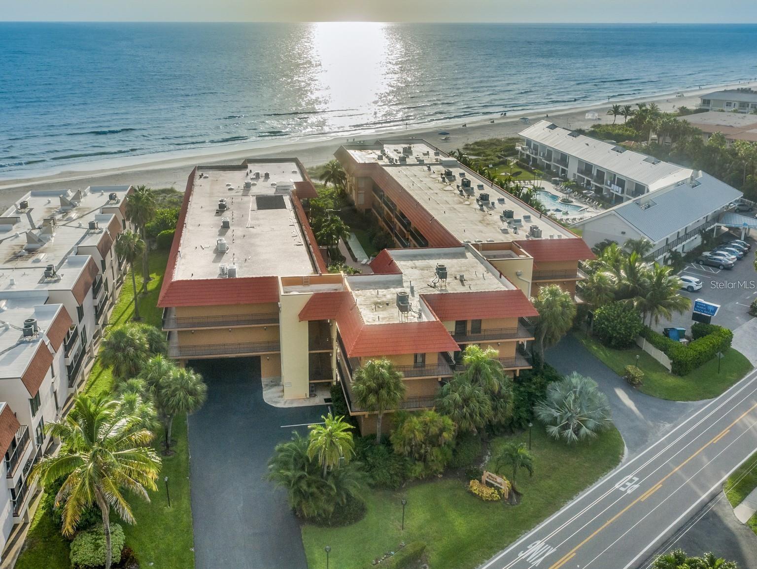THIS is the ultimate beachfront "Turn-Key" Investment where shorter-term rentals are permitted. Skip the furniture trucks and design stress and start enjoying a fully furnished vacation home that pays you when you're not using it! Located in the heart of one of the world’s top beaches, Anna Maria Island, this spacious and open concept features a 2-bedroom, 2-bathroom slice of paradise has a flexible 2 week rental policy with a proven track record. This unit is ready for your first sunset or your first rental guest the moment you close. With a "secret" beach access, you are steps away from the sugar-white sands of the Gulf. Enjoy what feels like a private beach experience with exclusive access points sets the mood for intimate sunsets front and center as this building only has 38 units on the beachside. Unlike many island properties, this unit has undergone a complete structural, foundation and reserve milestones so you can relax stress free. From the sparkling heated pool and spa to the tennis courts/pickleball, shuffleboard, elevator and lush tropical grounds, the entire complex radiates a "newly opened" resort energy. Bright and airy with ceramic tile throughout (perfect for sandy toes), plenty of closet space, two skylights for natural Florida sunshine along with being an end unit allowing more natural light, and a private lanai with entries from both the living room and primary suite to take in sunsets. 
The convenience of having underground assigned parking, a private storage locker for your beach gear, and an in-unit washer/dryer make living here feel like home! 
With the Hop on the free Island Trolley right outside to explore Pine Avenue's boutiques or walk to the nearby Holmes Beach Plaza, you’ll never run out of things to do whether you live on vacation or are actually on vacation. 
Invest in a property that works as hard as you do. Between the scarcity of beachfront units and the booming rental market on Anna Maria Island, Unit 207 is the smartest…and most beautiful…move you’ll make this year.
Pack your swimsuit and leave the rest to us. Schedule your showing today!