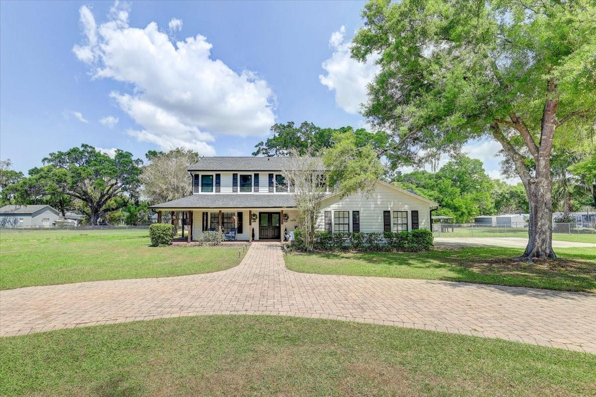 POOL HOME ON 1.76 ACRES in highly sought after Buckhorn Gulf Course Area: Experience the perfect blend of country charm and modern convenience —just minutes from city life, shopping, and dining. This expansive 5-BEDROOM, 4 FULL BATH, and 2 HALF BATH residence offers over 5,000 square feet under roof, thoughtfully designed for both comfort and entertaining. A grand entrance welcomes you as you pull into the CUSTOM PAVED CIRCLE DRIVE. The paved side walk leads you onto the huge WRAP-AROUND FRONT PORCH and sweeps you through CUSTOM DOUBLE DOORS into a stunning foyer, featuring a PRIVATE OFFICE to the left and a sleek modern staircase to the right. At the heart of the home is a massive, open-concept GOURMET KITCHEN equipped with GRANITE COUNTERTOPS throughout, a large BAR, DUAL SINKS, TWO WINE FRIDGES, GAS RANGE/OVEN, and an OVERSIZED refrigerator—perfect for hosting and everyday living. The kitchen flows seamlessly into the great room, living room, and formal dining area, where a WOOD-BURNING FIREPLACE adds warmth and elegance. A standout feature is the unique IN-LAW SUITE on the main level, offering ultimate privacy and luxury with DUAL TOILETS, DUAL SINKS, a spacious DUAL WALK-IN SHOWER with tile finishes, and TWO CUSTOM WALK-IN CLOSETS, all complemented by abundant natural light. Upstairs, you’ll find TWO PRIMARY SUITES. PRIMARY SUITE ONE is the luxurious main suite with a SPA-LIKE BATHROOM featuring a walk-in CUSTOM TILE SHOWER, modern TUB, DUAL SINKS set in GRANITE with beautiful tile finishes throughout. Step out onto your PRIVATE SCREENED BALCONY overlooking the pool, and fully fenced backyard. PRIMARY SUITE TWO is almost equally enchanting with TWO WALK-IN CLOSETS, a THIRD WALK-IN CLOSET OR OFFICE, LINEN CLOSET & large bedroom. There are two additional guest bedrooms with WALK-IN CLOSETS and a shared bath with shower/tub combo and DUEL SINKS set in GRANITE. All upstairs rooms feature energy-efficient THERMAL TRIPLE-PANE WELDED WINDOWS. Outdoor living is just as impressive, with a SCREENED LANAI, leading to a PAVED PATIO, SPARKLING POOL with a private pool 1/2 bath, and FIRE PIT—ideal for relaxing or entertaining. The expansive FULLY FENCED BACK YARD offers plenty of space for pets, gatherings, or outdoor activities. Storage shed conveys for extra storage space and the propane gas tank is under ground. Additional highlights include a private well, WHOLE HOUSE GENERATOR and septic system, along with numerous recent upgrades:
***2024: New shingle roof, New well pump, Pressure tank, Whole House water softener, New fence, New screened lanai****2025: Custom Apex Energy Solutions Windows thermal triple-pane welded frame (all upstairs windows replaced), New AC compressor and controller, Custom Apex Energy Solutions solid core front double doors. This one-of-a-kind property delivers space, privacy, and upscale features—country living at its finest with city conveniences. 30 minutes to DOWN TOWN TAMPA, 37 minutes to TAMPA INTERNATIONAL AIRPORT. THIS IS A MUST SEE!!!