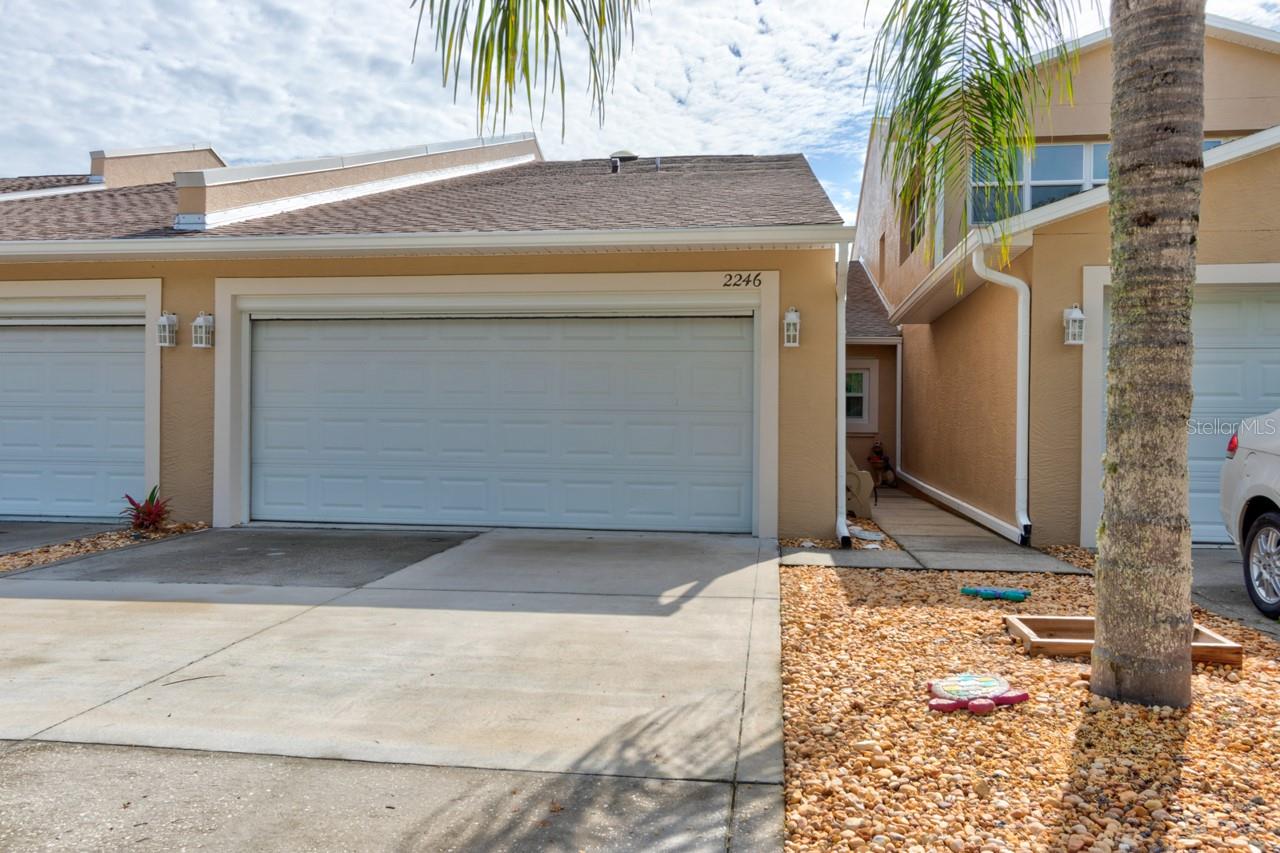 Welcome to easy Florida living at 2246 Hawks Cove Circle, a beautifully maintained east-facing townhome with peaceful pond views and a comfortable, well-designed floor plan. This move-in-ready home features attractive porcelain tile flooring throughout the living room, dining area and kitchen, with plush carpeting in the bedrooms and fresh interior and exterior paint for a clean, bright feel. The spacious primary suite offers a private retreat with an oversized walk-in closet and excellent storage. Thoughtful upgrades and improvements include automatic door-wall blinds, plantation-style shutters, generator electrical hookup, automatic garage screen, oversized garage shelving, new TV mounts, a new patio and walkway, all-new windows, Hurricane Shutters and insulated Cocrete form, new Washer Dryer Refridgerator + Dishwasher in 2025 and a recently replaced air conditioning system. Enjoy quiet mornings overlooking the water, relax in the screened outdoor living space, and take advantage of the low-maintenance Hawks Cove lifestyle with HOA-included exterior maintenance, community pool, recreational amenities, pest control, and common-area care. Ideally located just minutes from shopping, dining, I-95, Canal Street, Flagler Avenue, the beach, and the river, this charming townhome offers the perfect blend of comfort, convenience, upgrades, and tranquil pond-front living in New Smyrna Beach. Whether used as a full-time residence, seasonal retreat, or investment property, 2246 Hawks Cove Circle is an exceptional opportunity in one of the area’s most convenient residential communities.