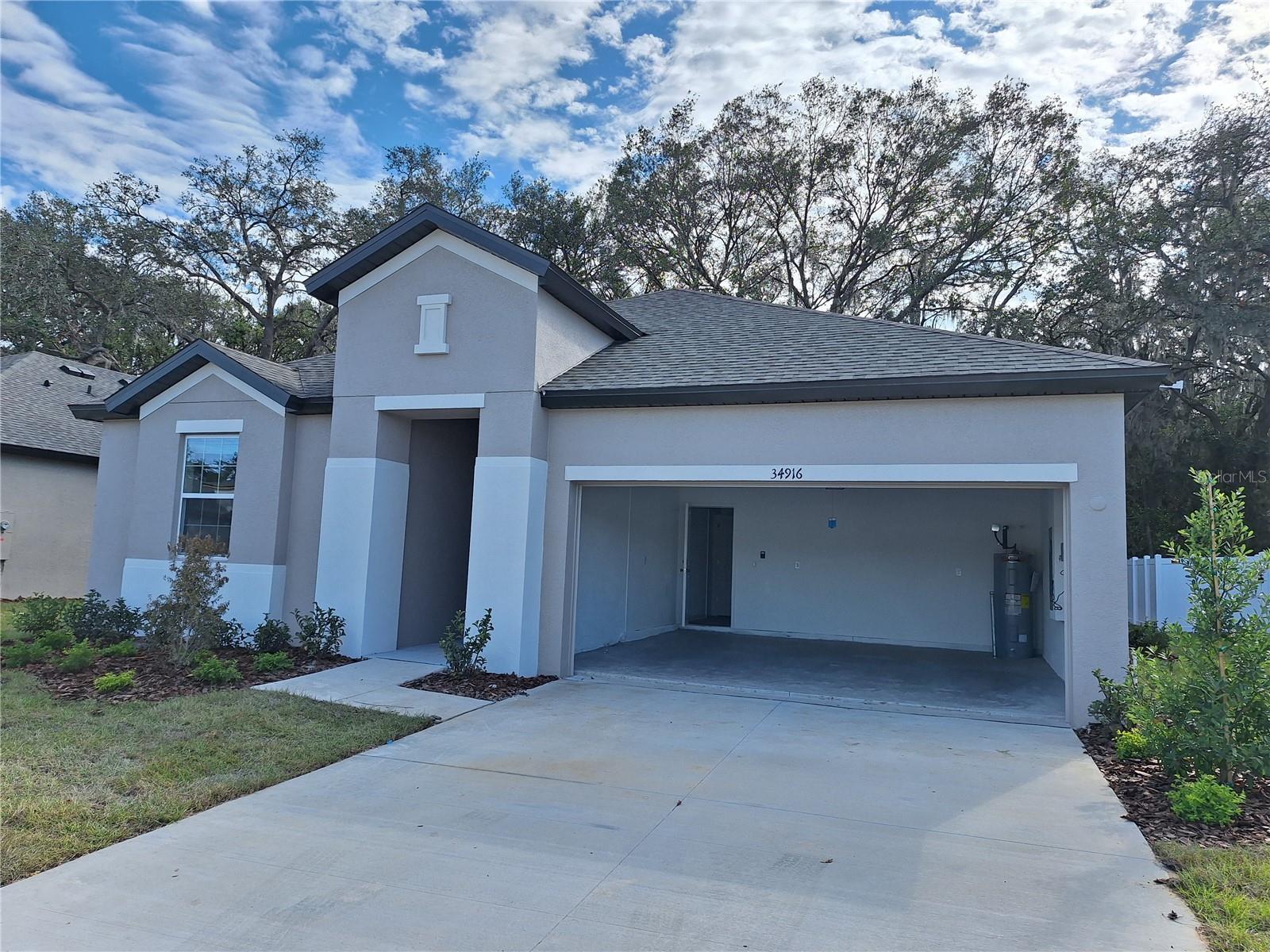 Welcome to this beautiful 2024-built single-story home in the desirable Lanier Acres community! This thoughtfully designed 3-bedroom, 2-bath residence offers 1,516 square feet of open living space with soaring 9'4" ceilings and a bright, functional split-bedroom floor plan. Step through the impressive 8-foot entry door into a spacious foyer that leads to an open-concept great room, perfect for everyday living and entertaining. The modern kitchen features quartz countertops, stainless steel appliances, an oversized pantry, a breakfast bar, and ample cabinet space. Luxury vinyl plank flooring flows through the main living areas, while the private owner's suite offers a spacious walk-in closet, dual vanities, and a large walk-in shower. Washer and dryer are included for added convenience. Enjoy outdoor living in the generous backyard with plenty of room for pets, play, or future landscaping. Additional features include a 2-car attached garage, smart home features, and an in-wall pest control system. Conveniently located just minutes from shopping, dining, schools, medical facilities, and major roadways including SR-54 and I-75, this move-in-ready home offers the perfect blend of comfort, style, and convenience. Schedule your private showing today!