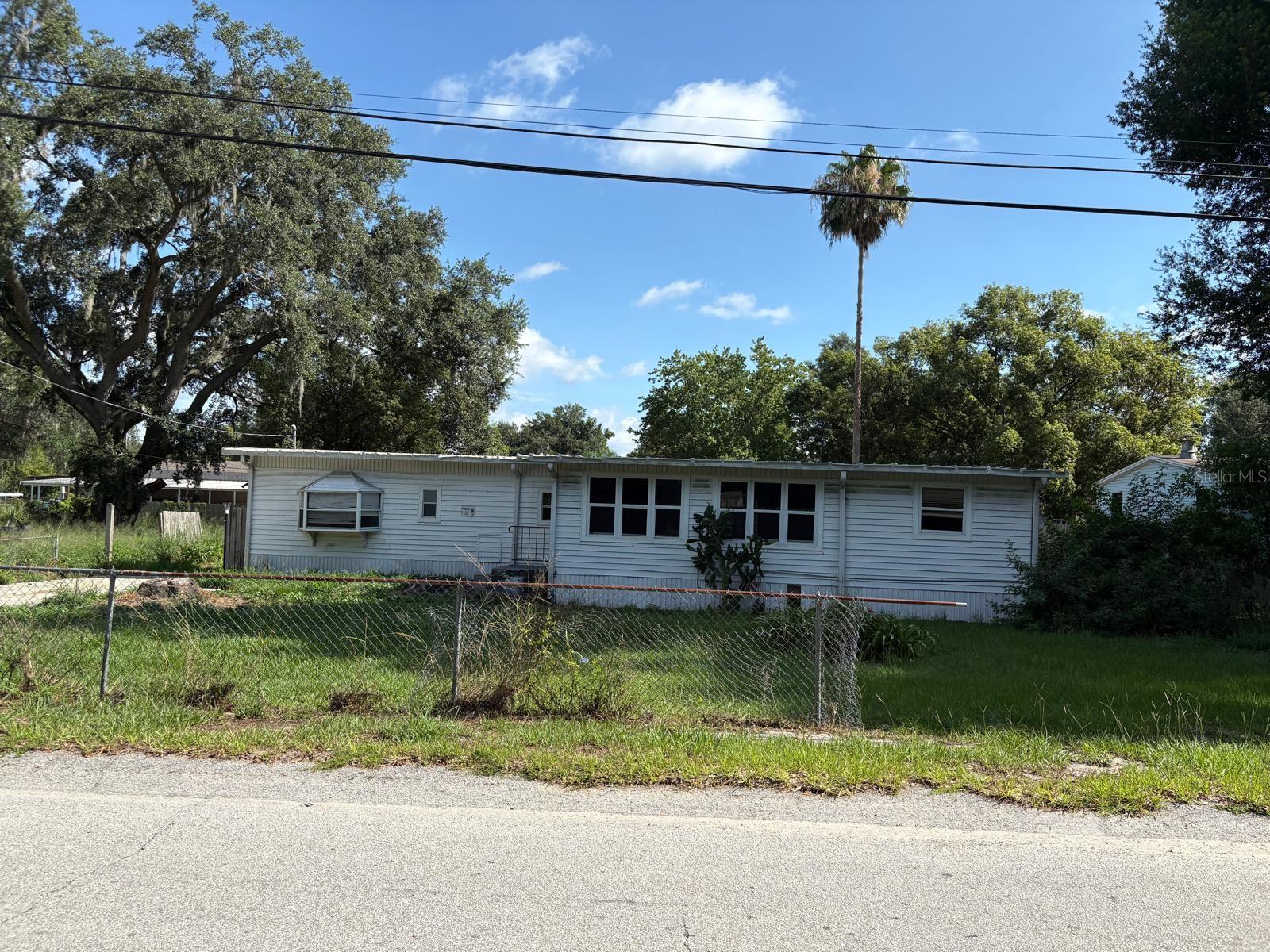 Amazing investment opportunity with NO HOA on a fenced 0.35-acre lot! This 3BR/1BA traditional-style home features central A/C, luxury vinyl flooring, and a dedicated laundry room. The expansive property includes a workshop and multiple storage sheds, offering plenty of room to build, create, or store equipment. Bring your creative ideas to update this handyman special and build instant equity. The seller is highly motivated, willing to assist with closing costs, and offering Owner Financing with down payment. Property is being sold as-is. All measurements to be verified by buyer. Don't miss out on this high-potential Winter Haven property!